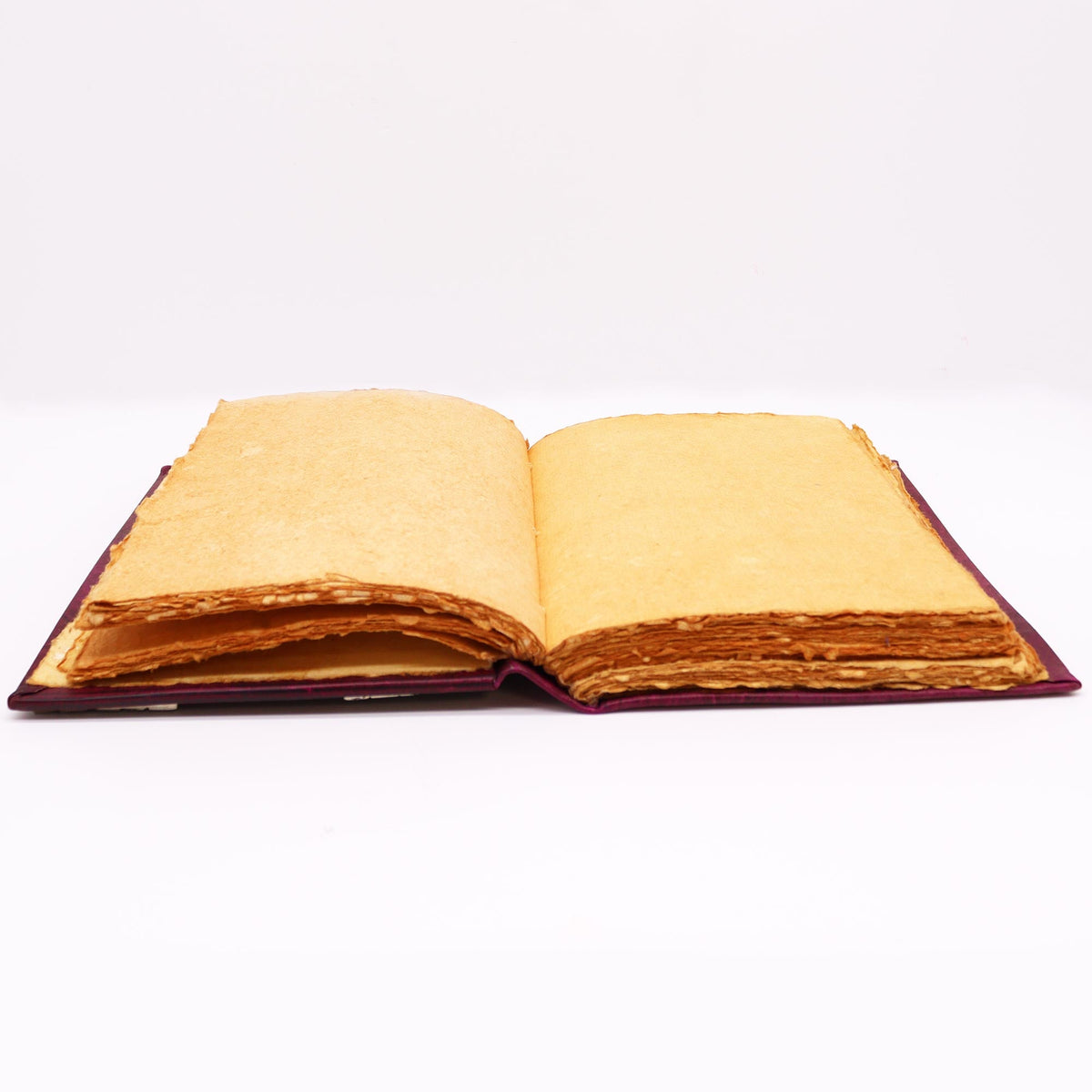 Extra-Large Burgundy Leather Deckle-Edged Journal - Zinc Hamsa, open with layered deckle-edged golden-toned pages visible by Quintessential Holistic Health Ltd