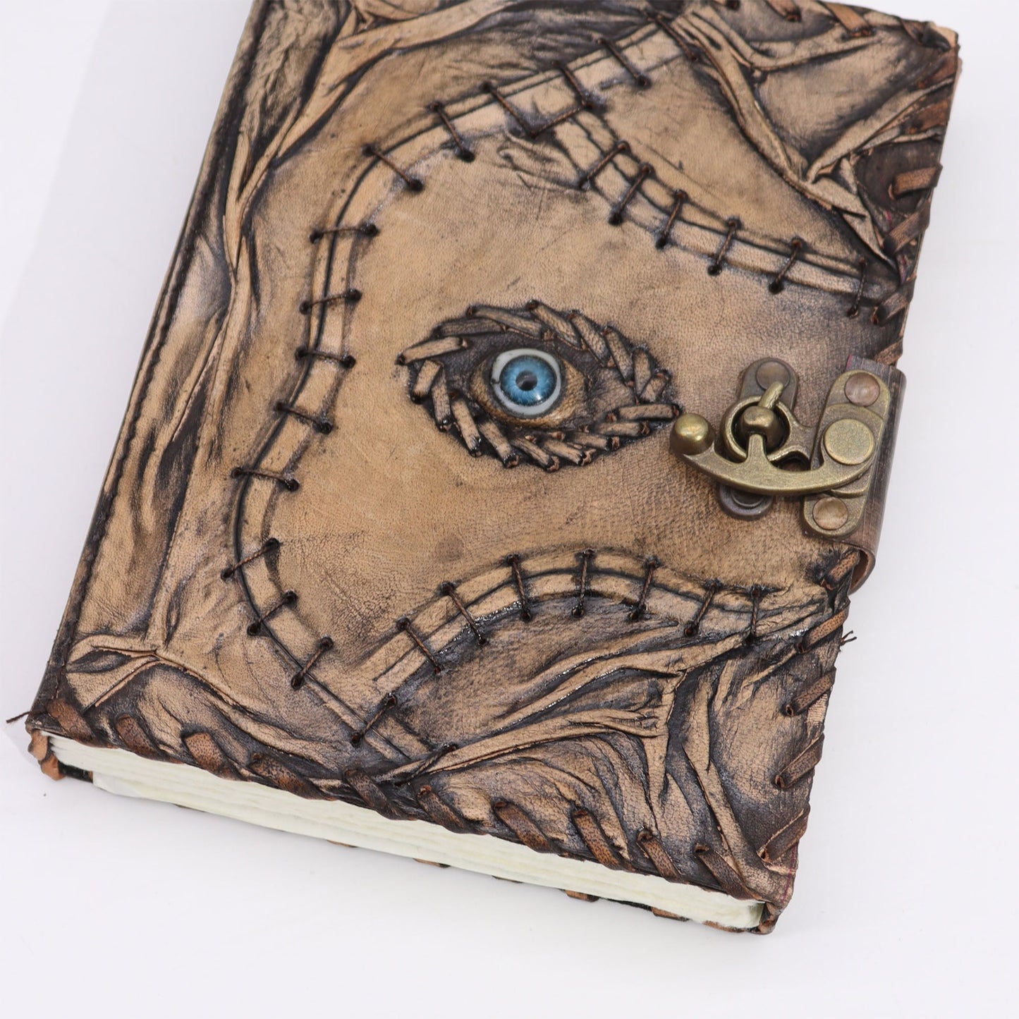 Large Tan Leather Notebook - Evil Eye - 160 Deckle-Edged Pages, angled view with embossed leaves, blue eye and clasp, by Quintessential Holistic Health Ltd