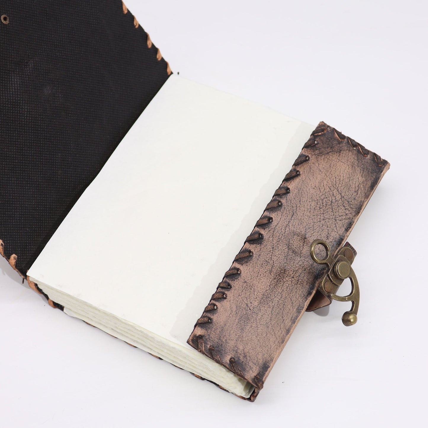 Large Tan Leather Notebook - Evil Eye - 160 Deckle-Edged Pages, opened to blank pages with a patterned cover edge, by Quintessential Holistic Health Ltd
