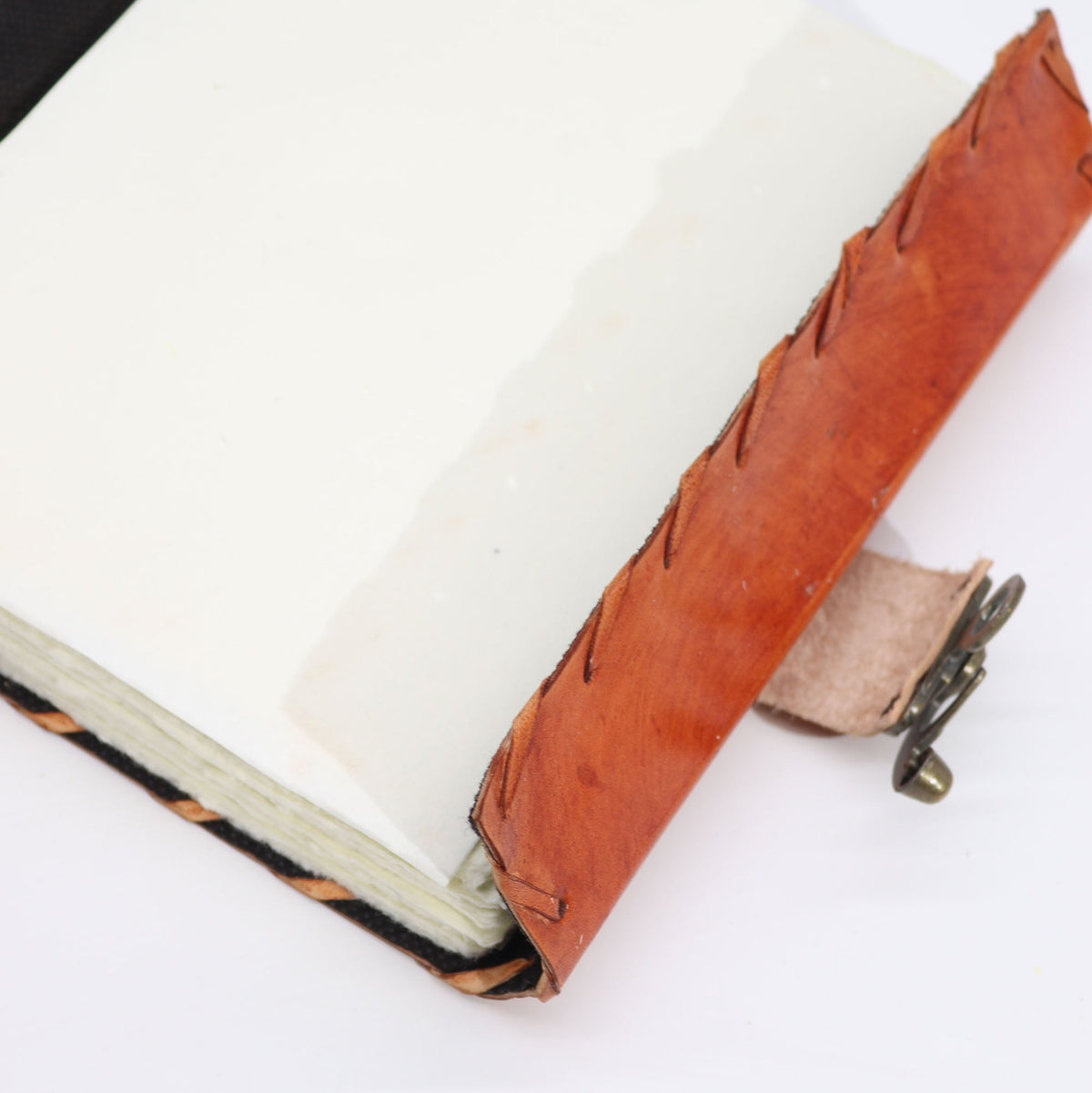 Large Light Brown Leather Notebook – Evil Eye, Deckle Edge, open with cream pages, stitched brown cover and metal clasp, by Quintessential Holistic Health Ltd