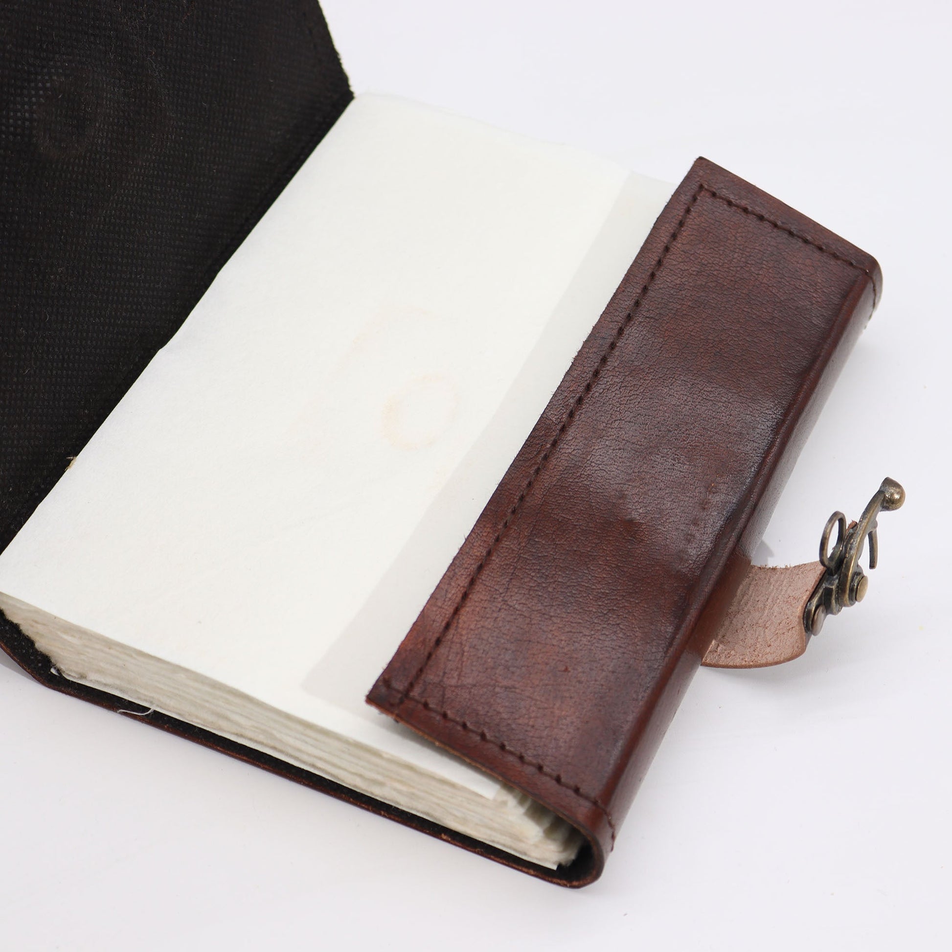 Medium Brown Leather-Bound Notebook - Evil Eye, Clasp & Deckle Edges, open to blank pages with the wraparound strap extended by Quintessential Holistic Health Ltd