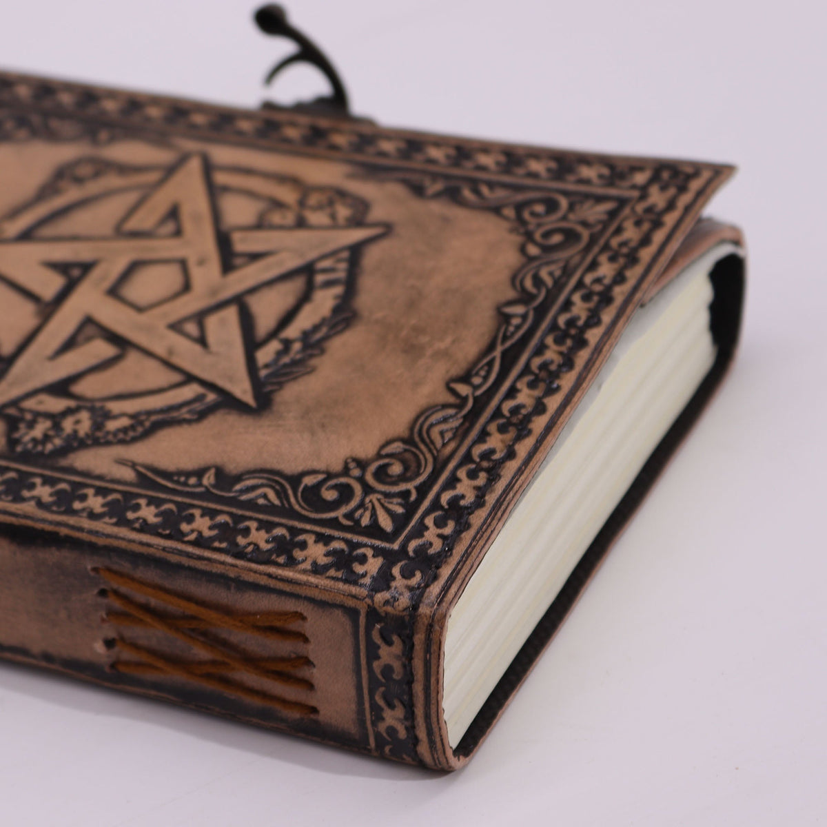 Handmade Leather-Bound Pentacle Notebook - Medium - Brown & Tan, showing the embossed cover, page edges and stitched spine, by Quintessential Holistic Health Ltd