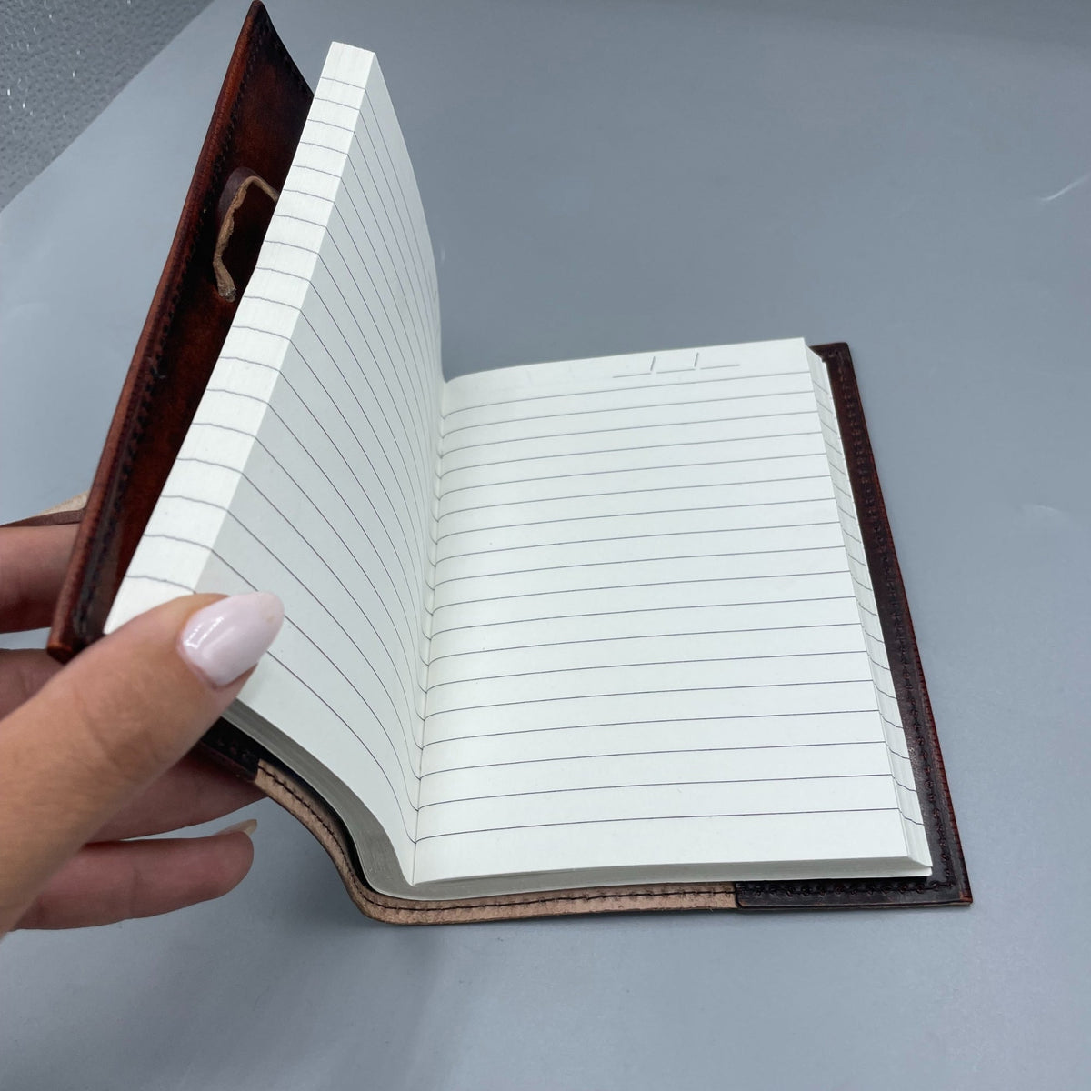 Handmade Leather-Bound Eco-Friendly - Medium - Brown - Tree of Life open to lined pages with the embossed cover visible by Quintessential Holistic Health Ltd