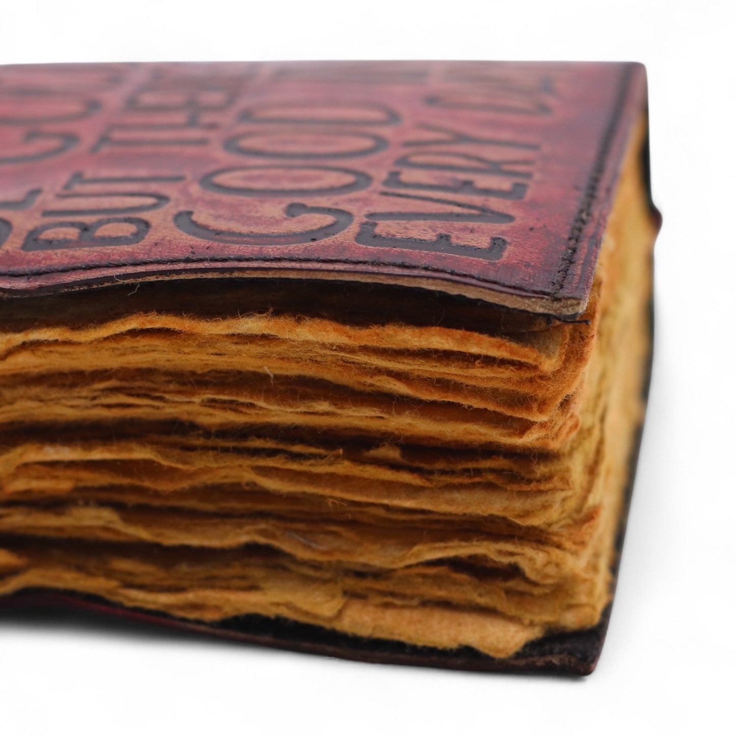 Small Brown Deckle-Edged Leather Wrap Journal - Good in Every Day close-up showing layered deckle-edged pages and the lettered cover by Quintessential Holistic Health Ltd