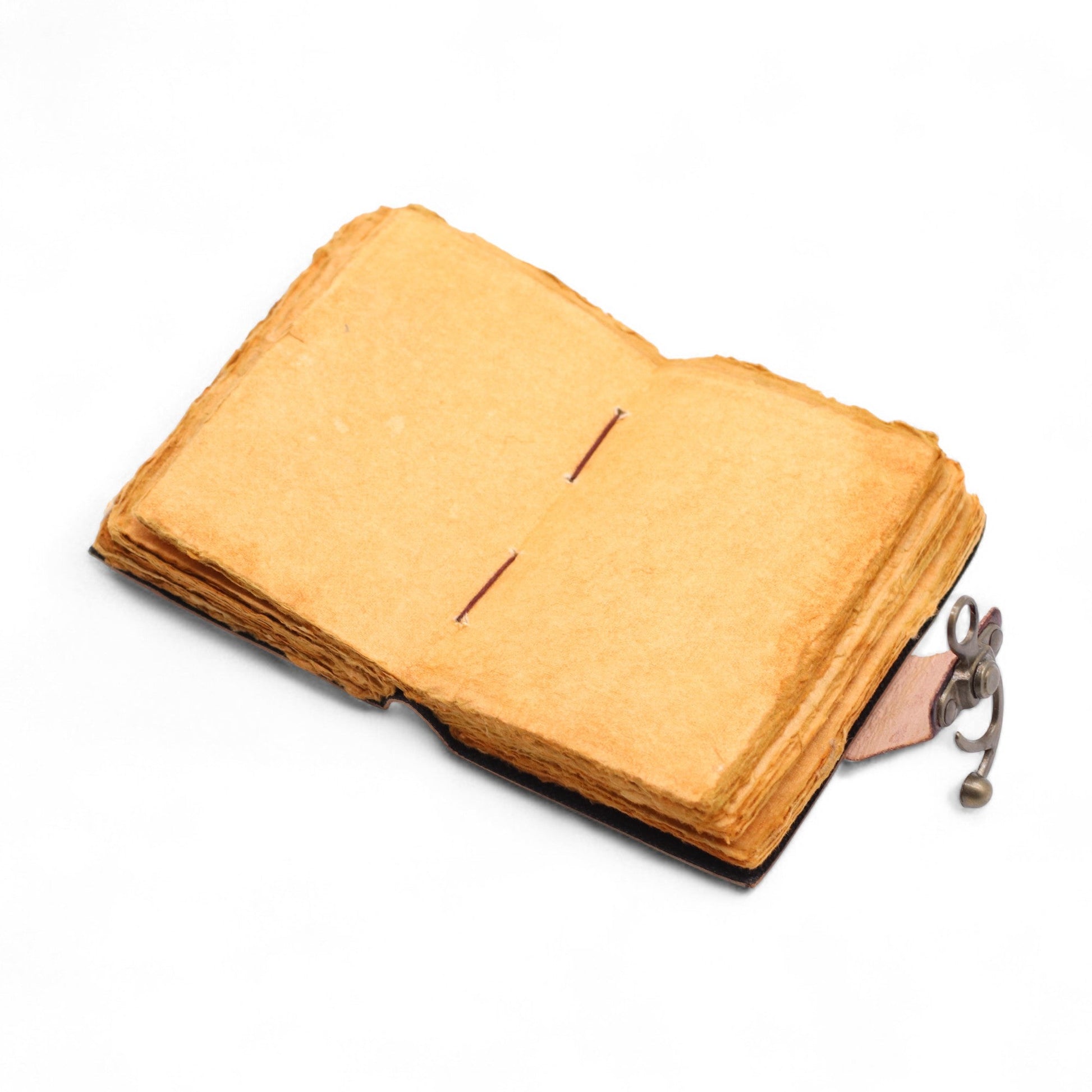 Small Brown Leather Journal - The Book of Untold Stories, lying open to blank tan pages with its metal clasp extended at the side by Quintessential Holistic Health Ltd