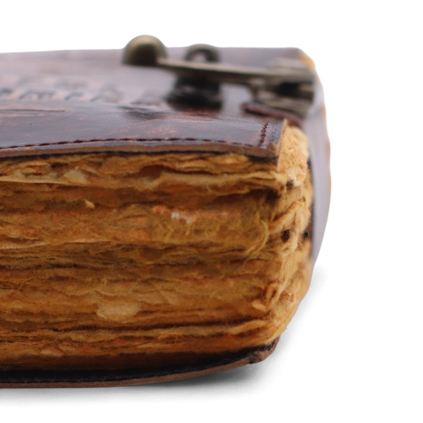 Small Brown Leather Journal - The Book of Untold Stories, close-up of thick, uneven golden page edges beneath the closed cover by Quintessential Holistic Health Ltd