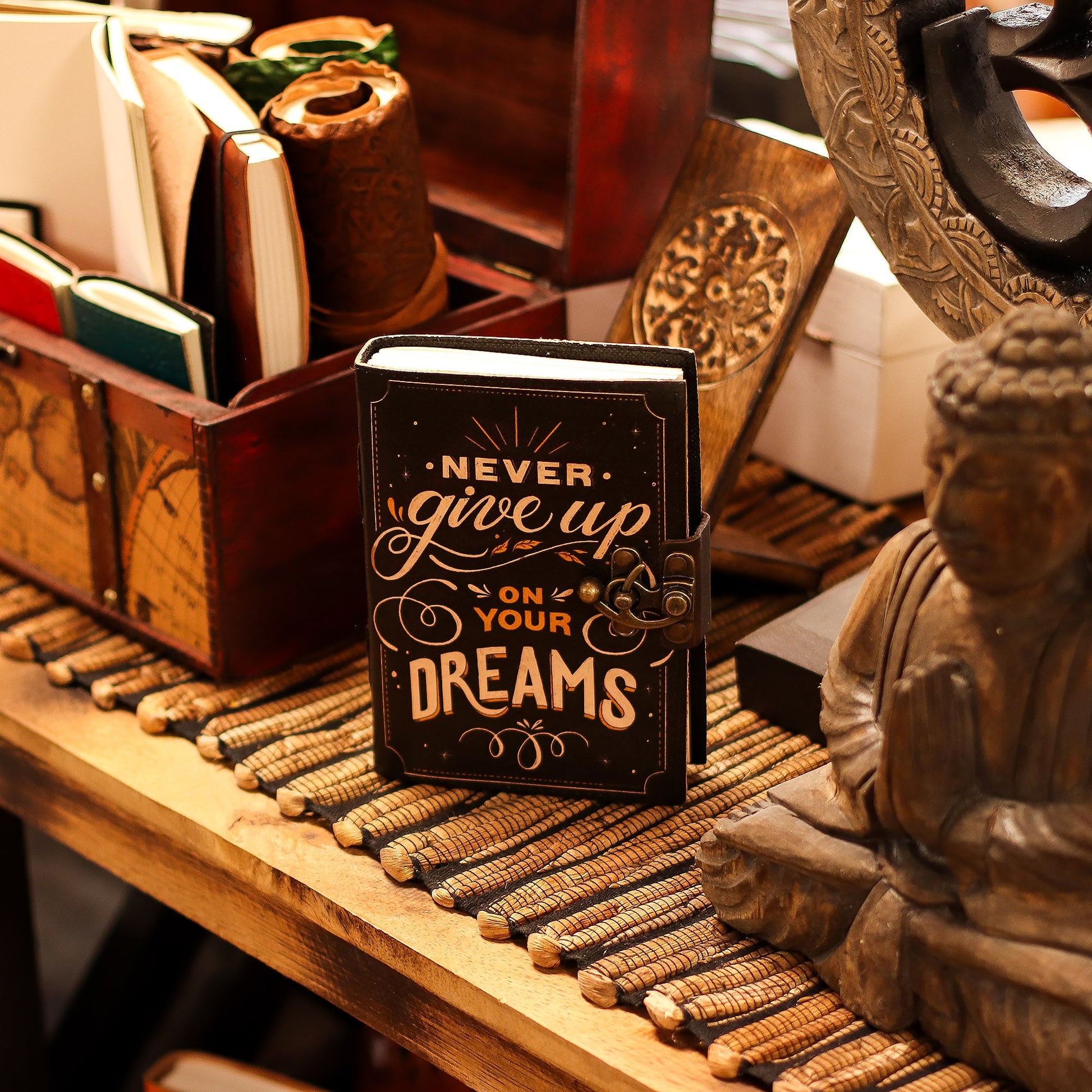 Handmade Leather-Bound Eco-Friendly Journal with Metal Clasp – Medium / Black / Never Give Up On Your Dreams product packaging on clean background from Quintessential Holistic Health Ltd