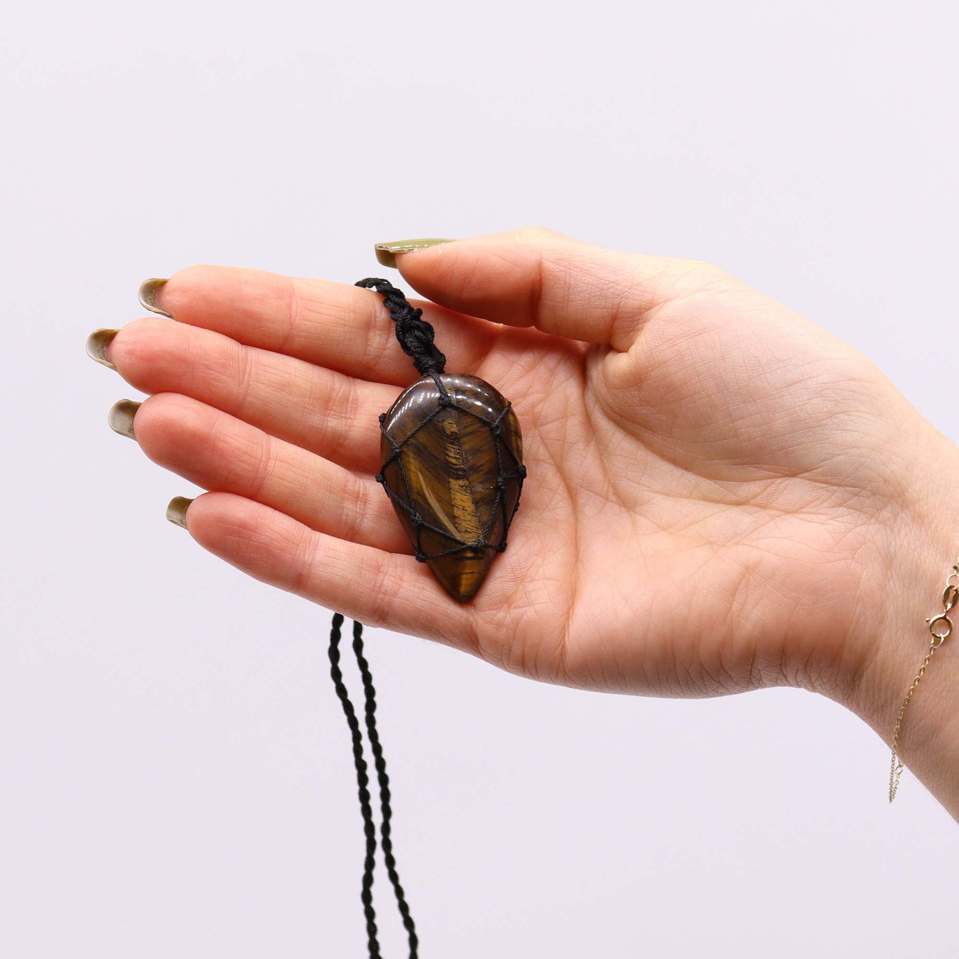 Handmade Laced Gemstone Pendant - Teardrop / Tigers Eye product packaging on clean background from Quintessential Holistic Health Ltd