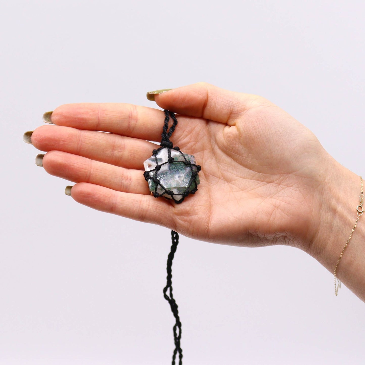 Handmade Laced Gemstone Pendant - Hexagonal / Moss Agate product packaging on clean background from Quintessential Holistic Health Ltd
