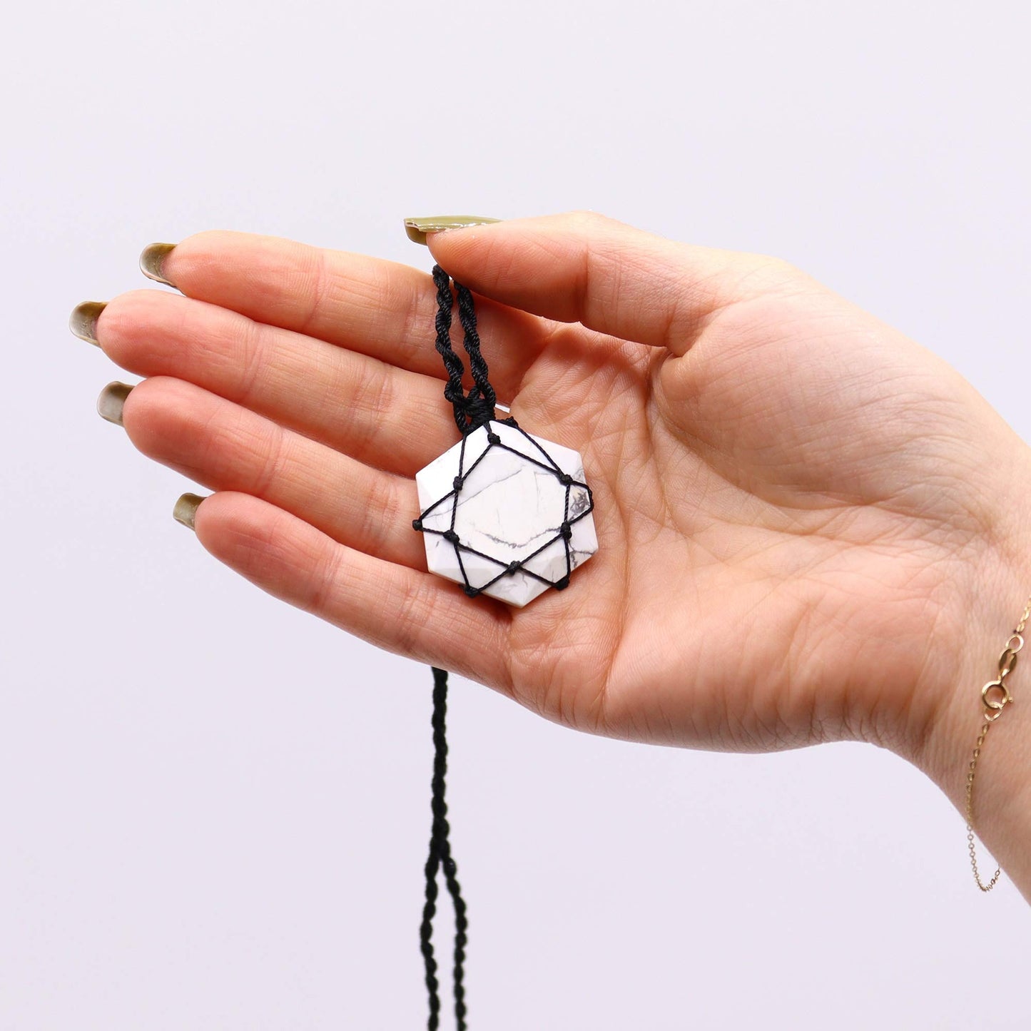 Handmade Laced Gemstone Pendant - Hexagonal / White Howlite product packaging on clean background from Quintessential Holistic Health Ltd