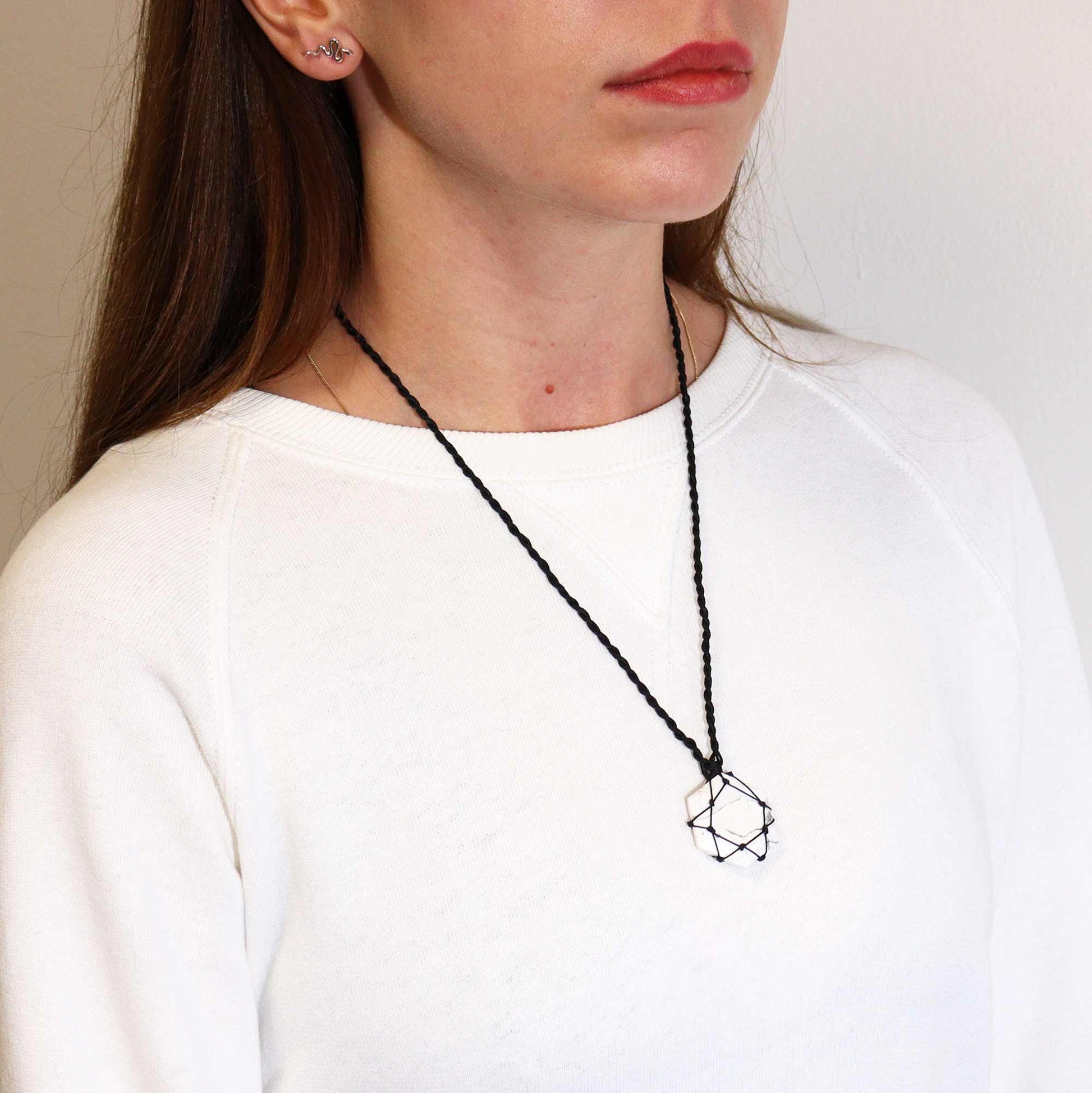 Handmade Laced Gemstone Pendant - Hexagonal / White Howlite product packaging on clean background from Quintessential Holistic Health Ltd