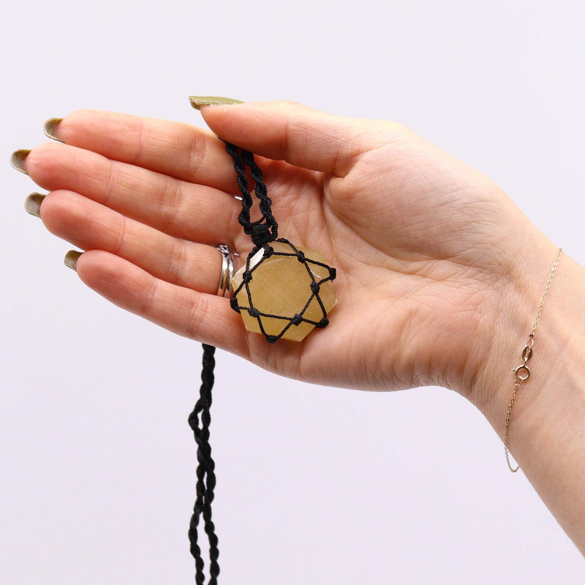 Handmade Laced Gemstone Pendant - Hexagonal / Yellow Quartz product packaging on clean background from Quintessential Holistic Health Ltd