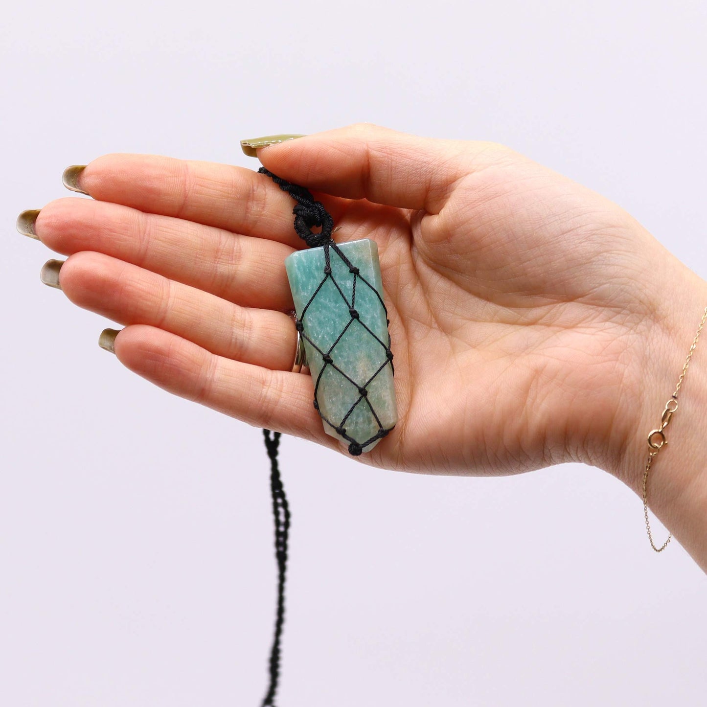 Handmade Laced Gemstone Pendant - Flat Point / Amazonite product packaging on clean background from Quintessential Holistic Health Ltd