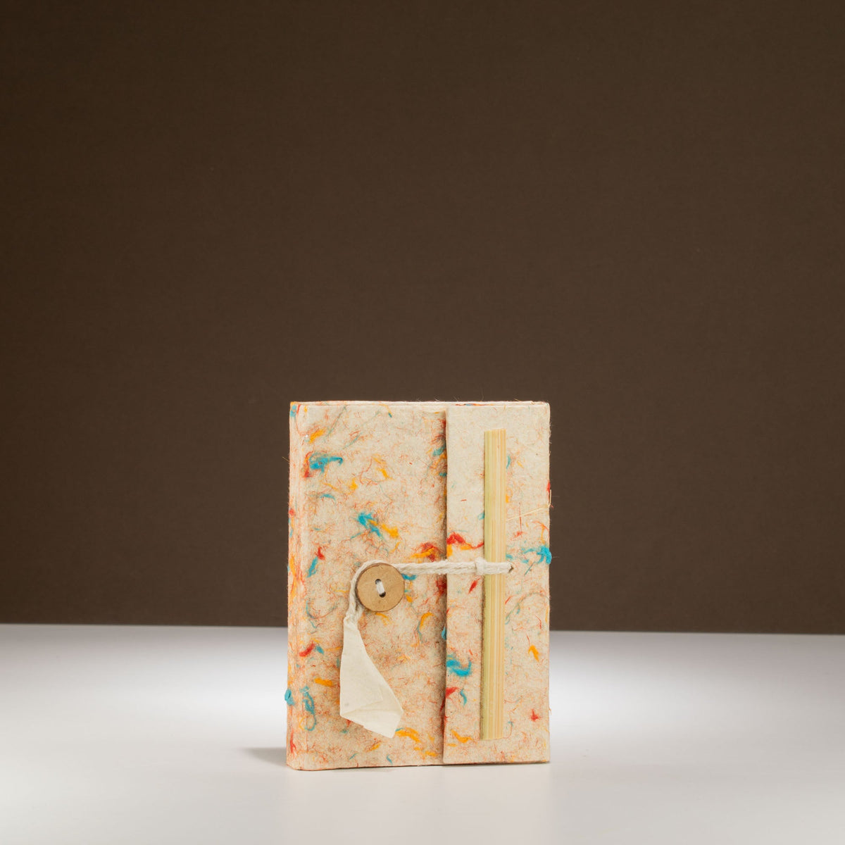Pocket Eco-Friendly Lokta Paper Notebook - Mixed Colour Cotton, upright cream notebook with orange, blue and green flecks by Quintessential Holistic Health Ltd