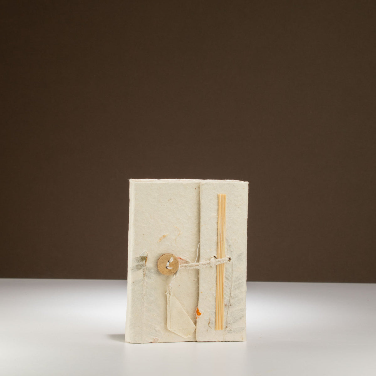 Pocket Eco-Friendly Lokta Paper Notebook - Mixed Flowers, pale upright notebook with subtle floral fibres and orange flecks by Quintessential Holistic Health Ltd
