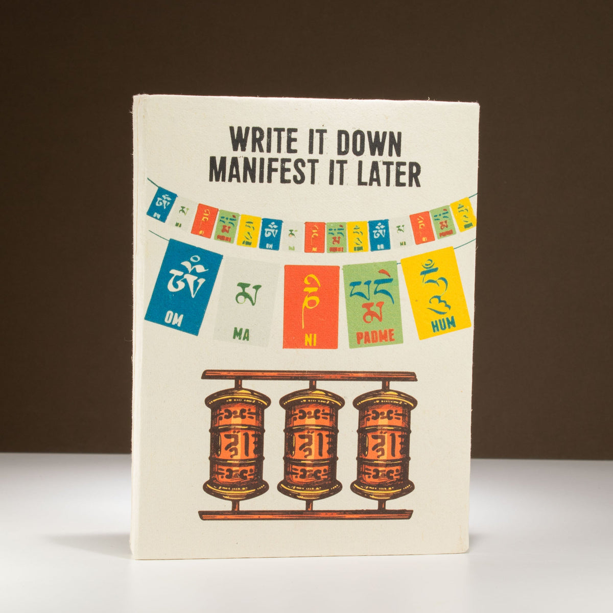 A5 Lokta Paper Journal & Bookmark - Write It Down, Manifest It Later, with multicoloured flags and three orange prayer wheels, by Quintessential Holistic Health Ltd