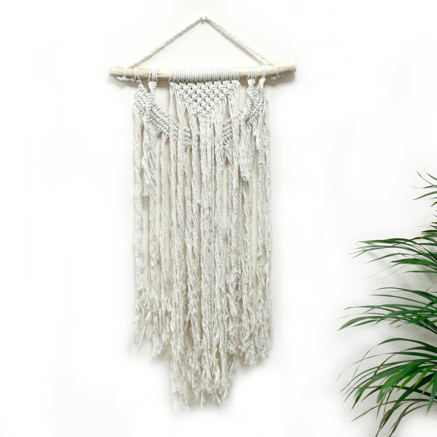 Handcrafted Cotton Macramé Wall Hanging - Force of Nature, narrow knotted panel with curved central loops and uneven fringe by Quintessential Holistic Health Ltd