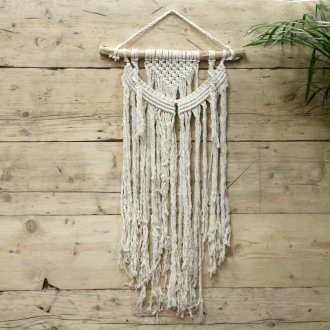 Handcrafted Cotton Macramé Wall Hanging - Force of Nature, layered curved knotwork and long textured fringe suspended from a branch by Quintessential Holistic Health Ltd