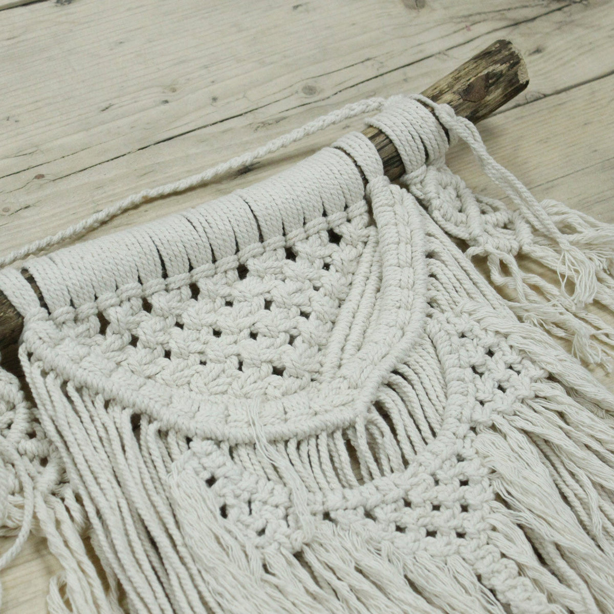 Handcrafted Cotton Macramé Wall Hanging - Natural Abundance, close-up of layered semicircular bands, open knotwork and fringe by Quintessential Holistic Health Ltd
