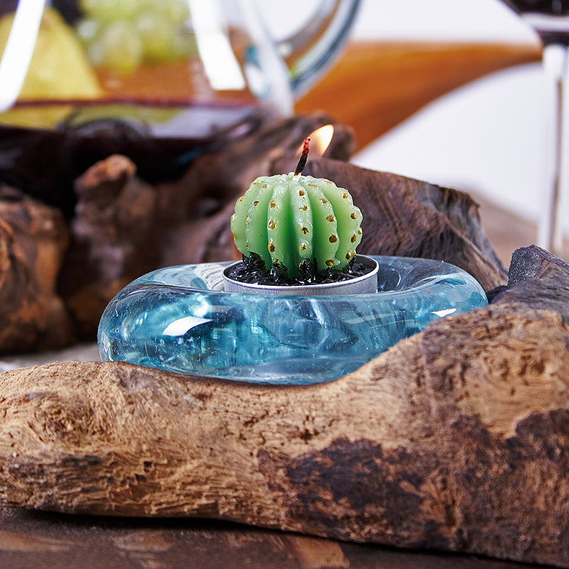 Recycled Glass Candle Holder on Wood - Single Round - Blue with a small green cactus-shaped candle in the glass cup by Quintessential Holistic Health Ltd