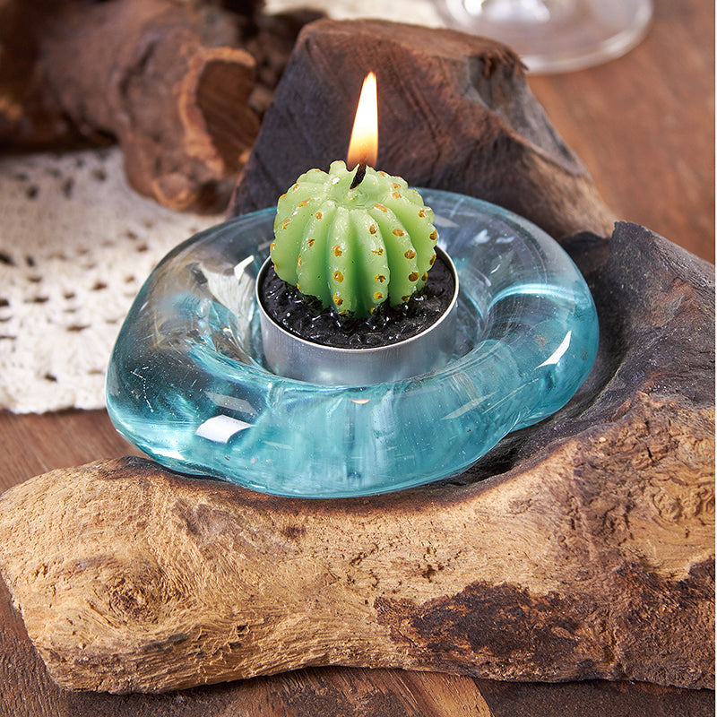 Recycled Glass Candle Holder on Wood - Single Round - Blue with a lit green cactus-shaped candle in the glass cup by Quintessential Holistic Health Ltd