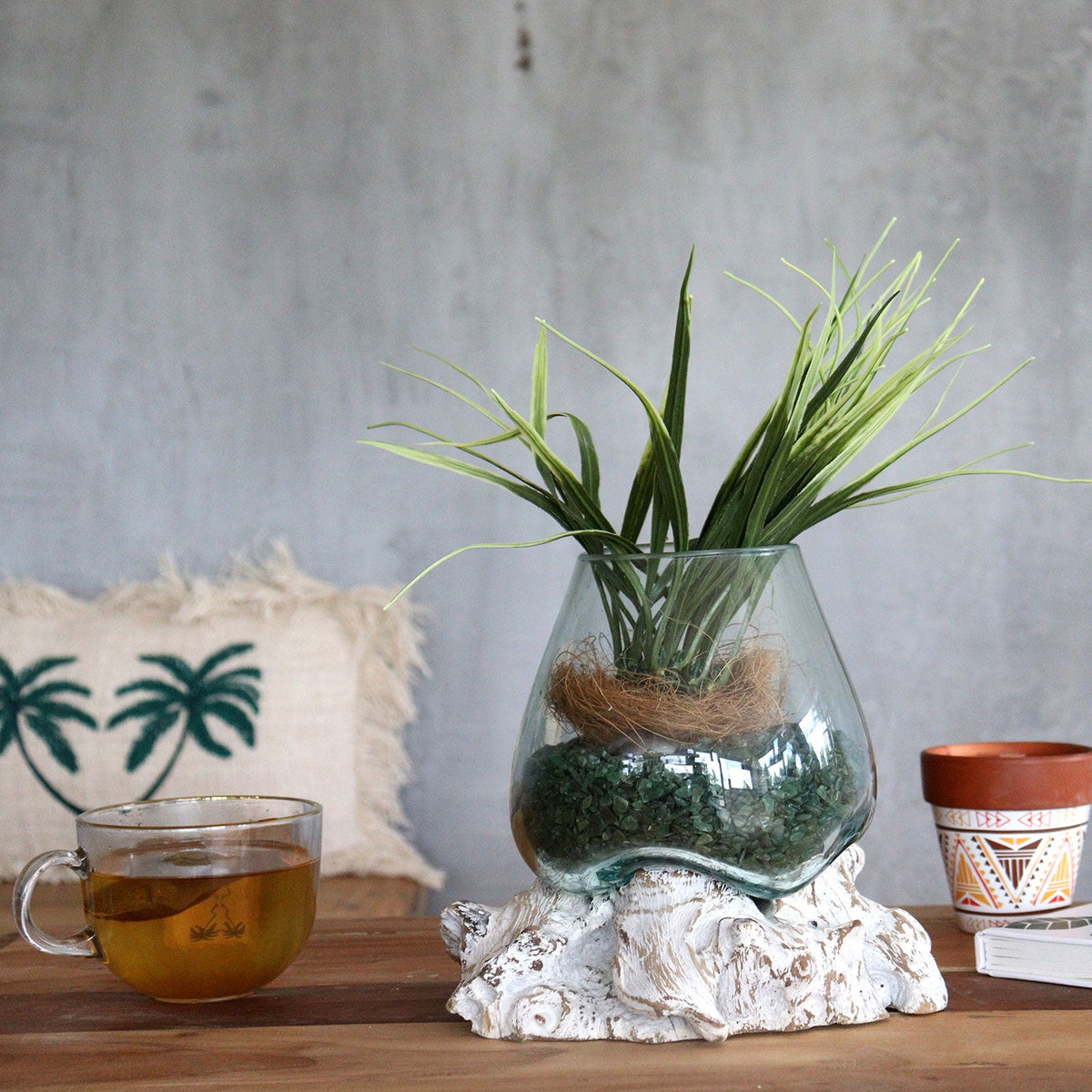Recycled Glass Vase - Small Oval - Clear/Blue - Whitewash, holding green foliage on a tabletop beside a cup by Quintessential Holistic Health Ltd
