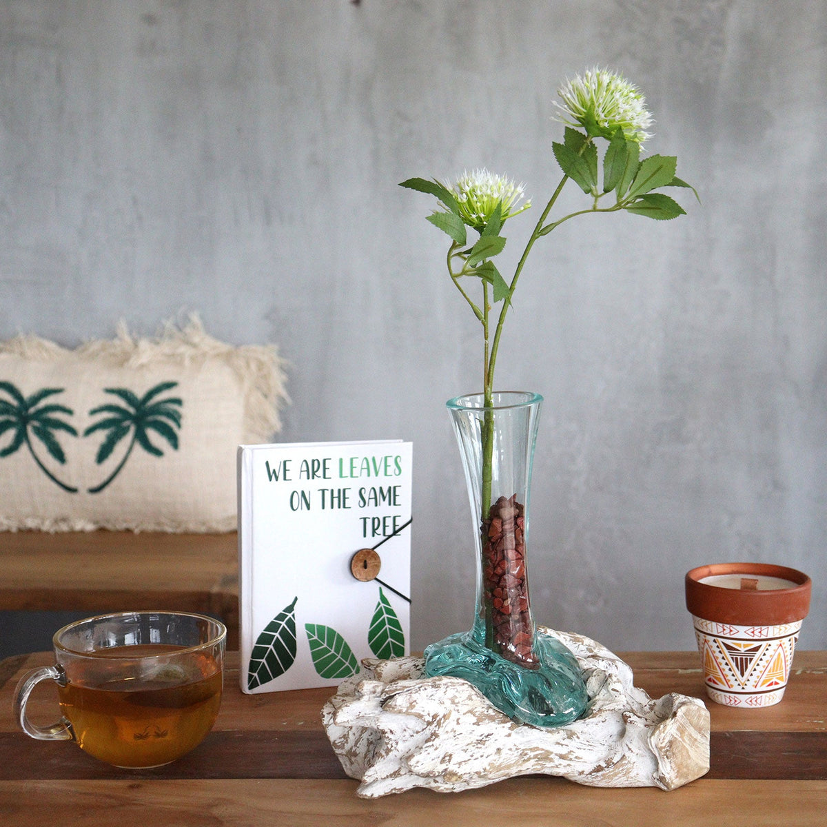 Recycled Glass Vase on Wood - Large - Light Blue, holding a green stem with a white flower in its tall narrow neck by Quintessential Holistic Health Ltd