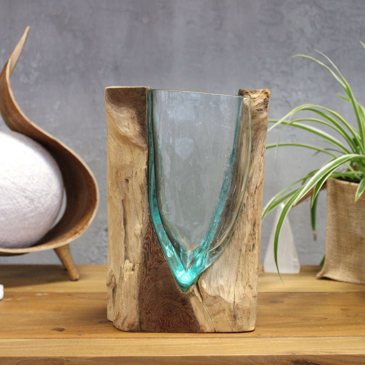 Handmade Molten Recycled V Shaped Vase - Clear and Light Blue, with an elongated pointed glass base between natural wood sides by Quintessential Holistic Health Ltd