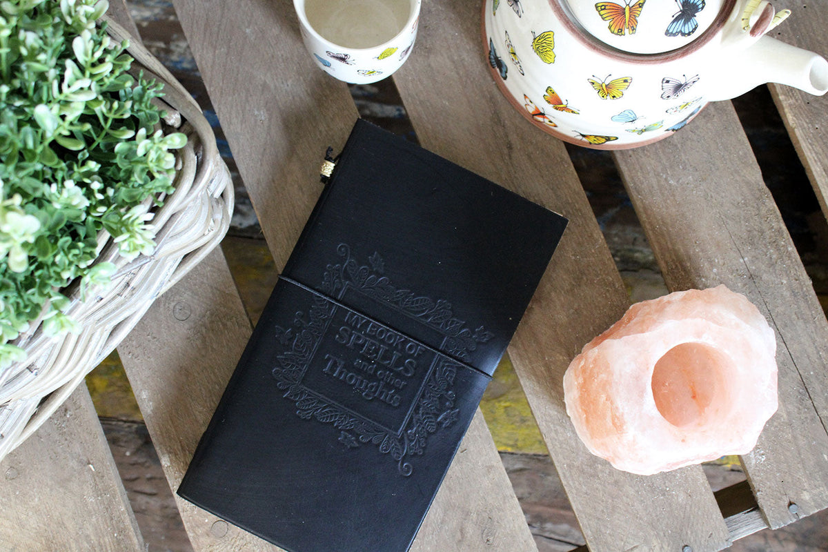 Slim Leather Journal - Black - My Book of Spells and Other Thoughts, with an ornate embossed title panel and matching dark page edges, by Quintessential Holistic Health Ltd
