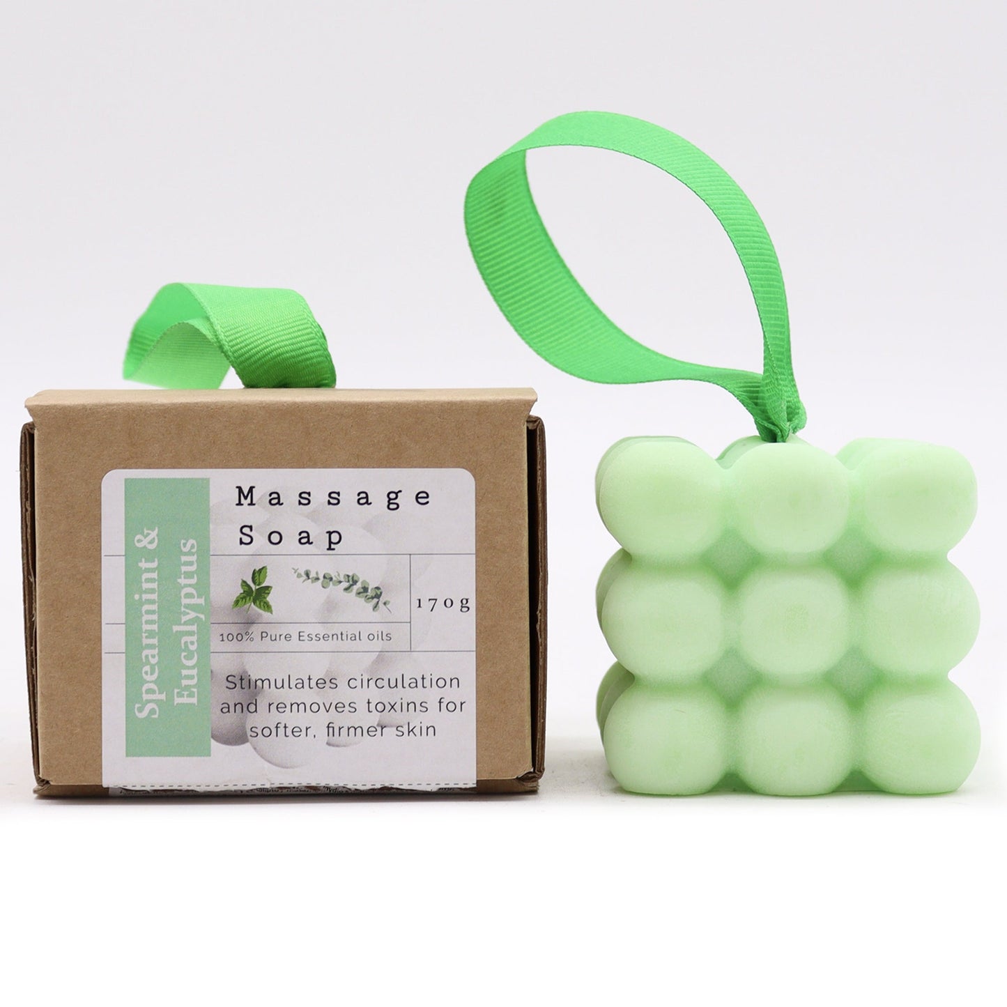 Massage Soap Bar - Spearmint and Eucalyptus, with a pale green bubble design and green loop beside a labelled brown box by Quintessential Holistic Health Ltd