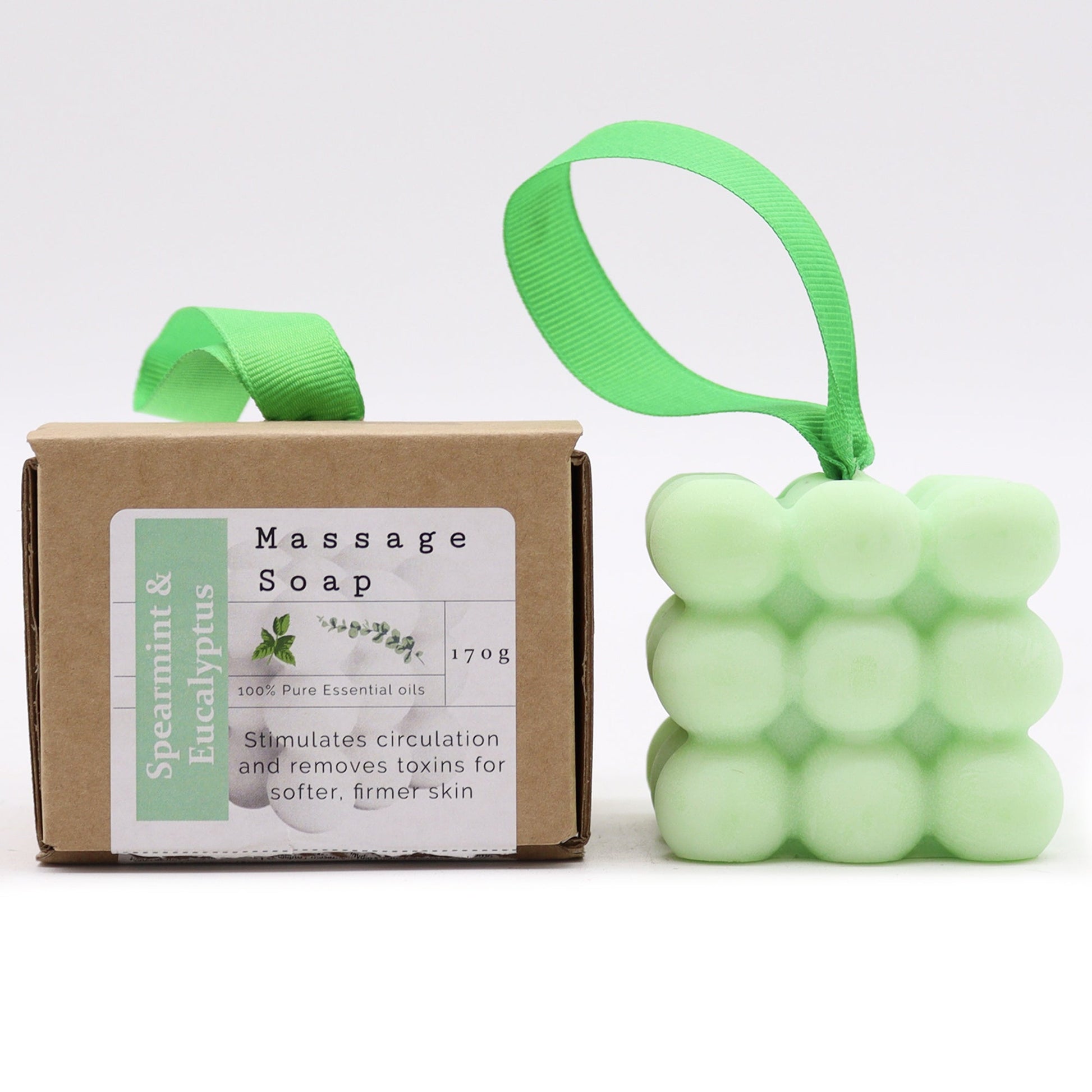 Massage Soap Bar - Spearmint and Eucalyptus, with a pale green bubble design and green loop beside a labelled brown box by Quintessential Holistic Health Ltd
