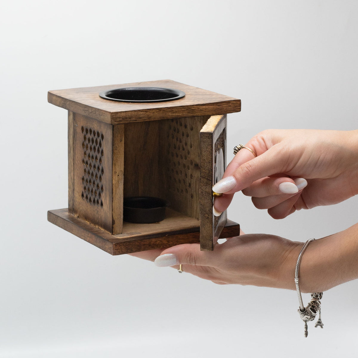 Eco-Friendly Mango Wood Box Oil or Tealight Burner - Elephant, held in two hands with its side door open by Quintessential Holistic Health Ltd