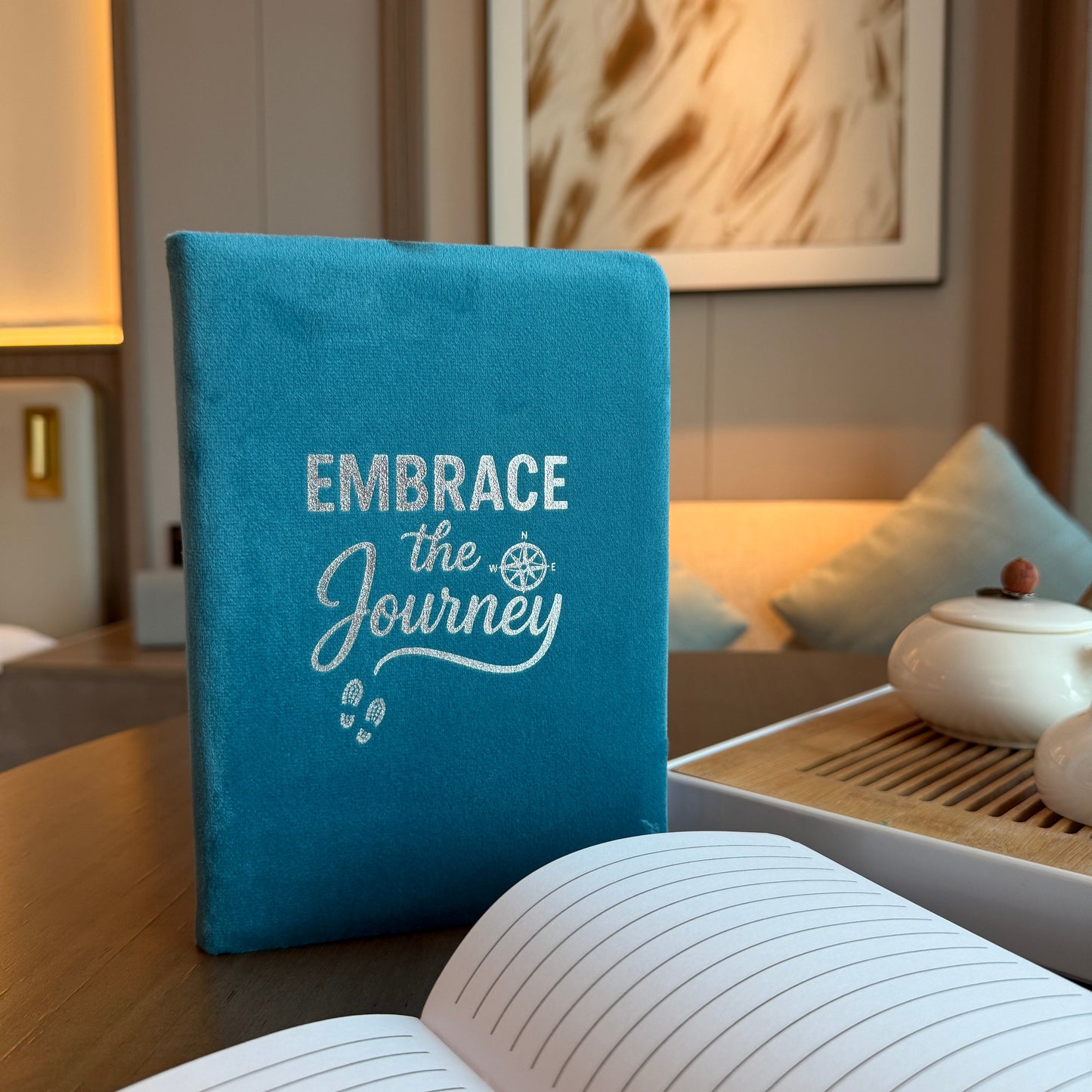 A5 Light Blue Velvet Journal – Embrace the Journey, upright blue journal beside an open notebook and white cup, by Quintessential Holistic Health Ltd