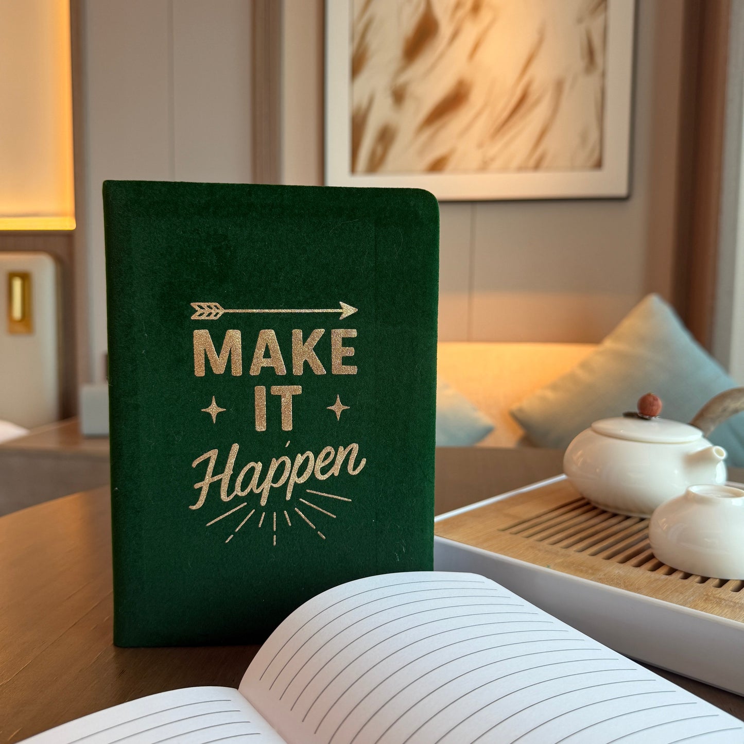 A5 Dark Green Velvet Journal - Make It Happen, upright closed journal beside an open lined journal and white teapot by Quintessential Holistic Health Ltd