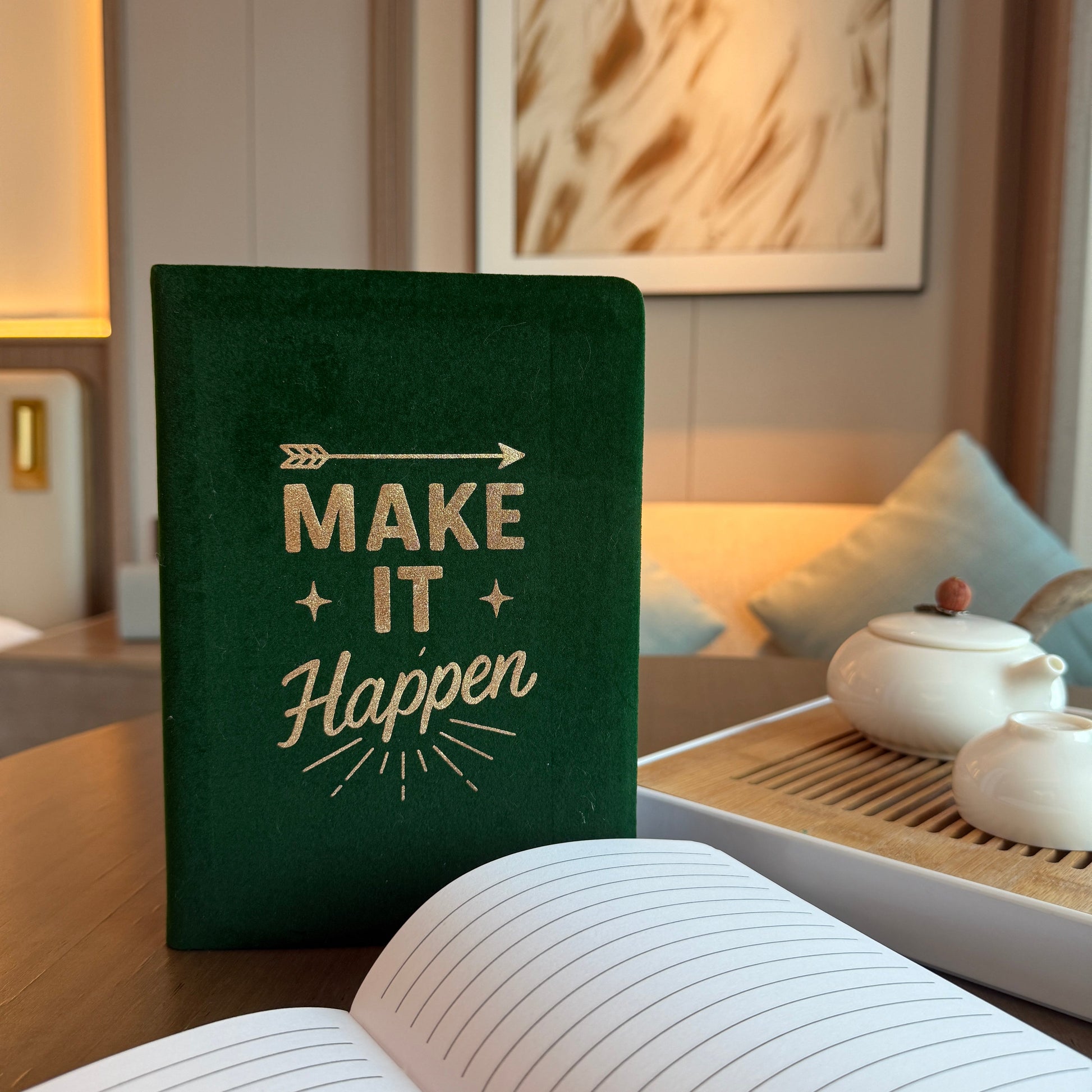 A5 Dark Green Velvet Journal - Make It Happen, upright closed journal beside an open lined journal and white teapot by Quintessential Holistic Health Ltd