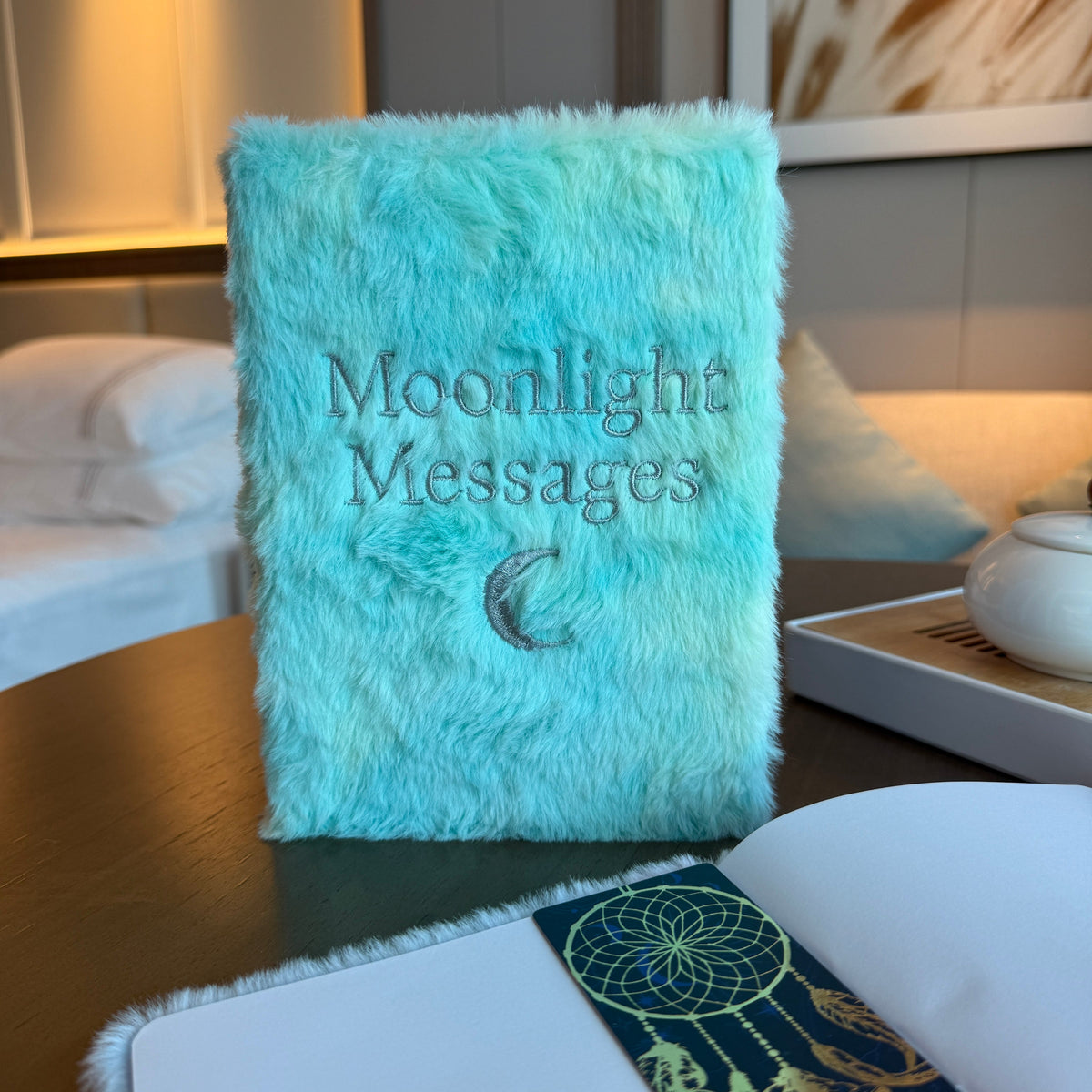 Soft Journal - A5 - Pastel Blue and Yellow - Moonlight Messages, upright with dark lettering and a crescent moon on the turquoise cover by Quintessential Holistic Health Ltd