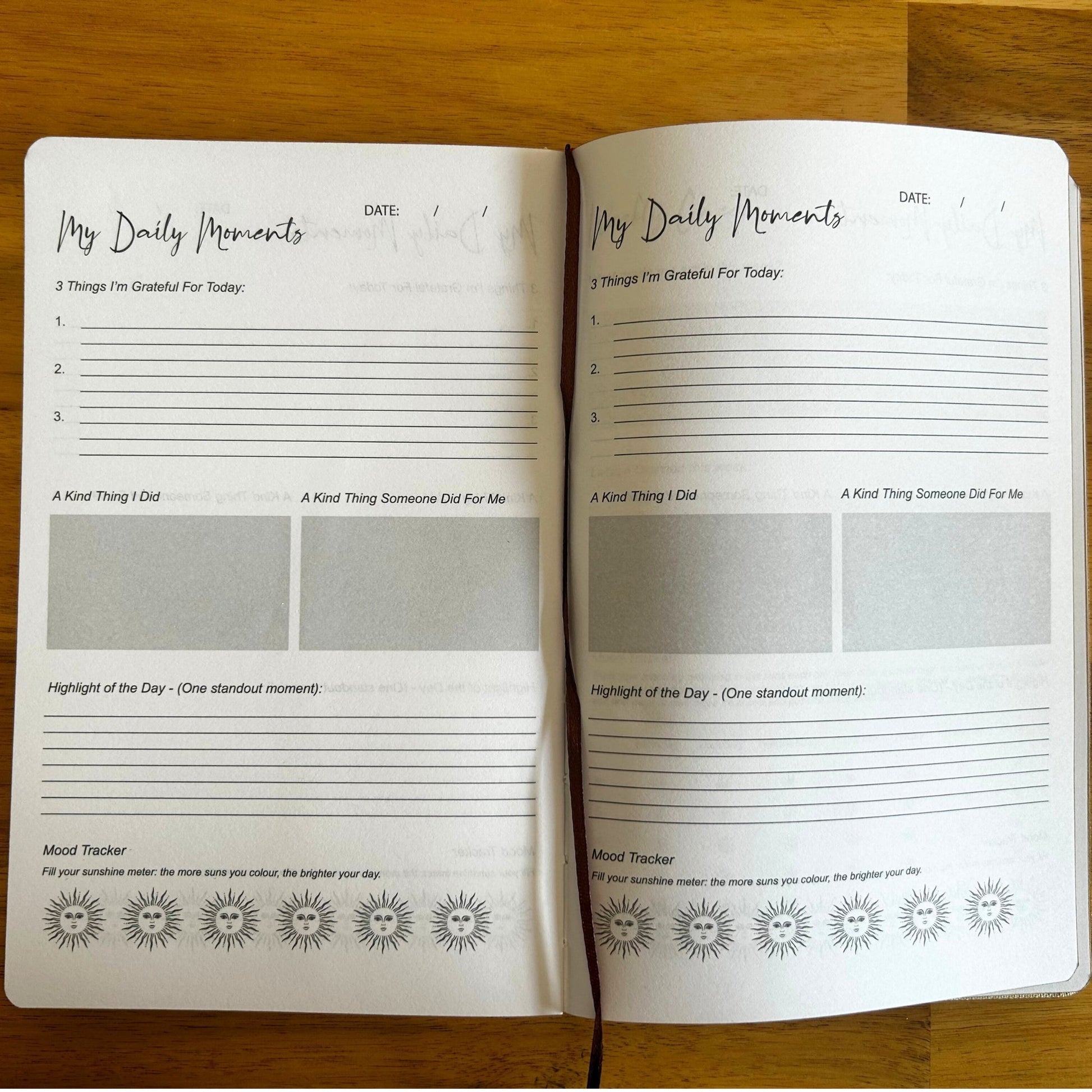 A5 Blue 'I Am Thankful For' Journal with Silver Lining, open to two My Daily Moments guided pages by Quintessential Holistic Health Ltd