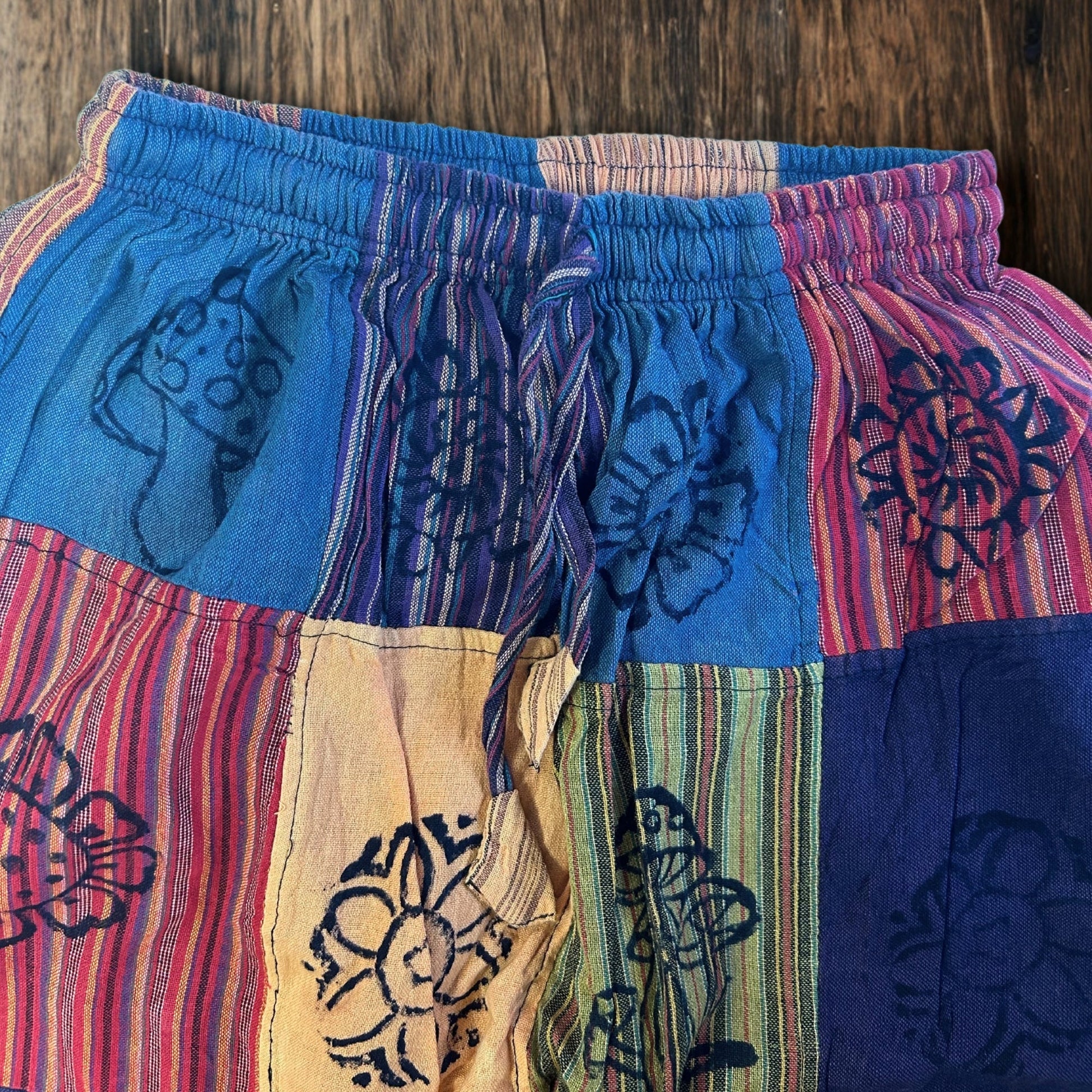 Nomad Sari Unisex Mushroom Pants - Small - Medium / Block Print / Orange Tones product packaging on clean background from Quintessential Holistic Health Ltd