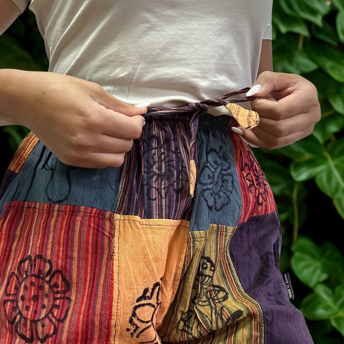 Nomad Sari Unisex Mushroom Pants - Small - Medium / Block Print / Orange Tones product packaging on clean background from Quintessential Holistic Health Ltd