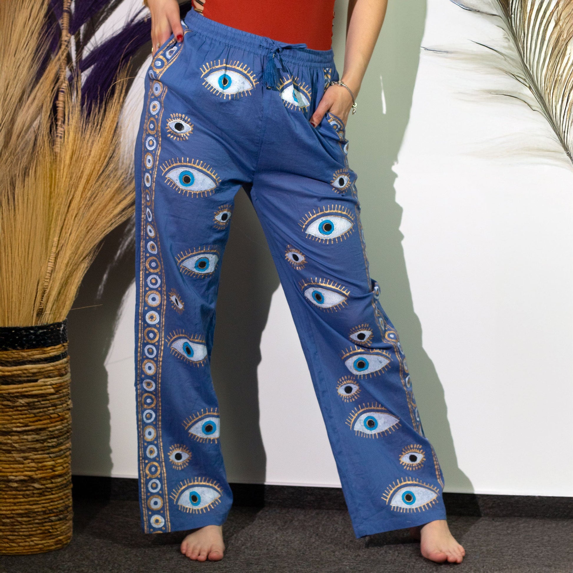 Nomad Sari Hand Painted Eco-Friendly 100% Cotton Lounge Pants - Large - Extra Large / All Seeing Eye / Blue and Gold product packaging on clean background from Quintessential Holistic Health Ltd