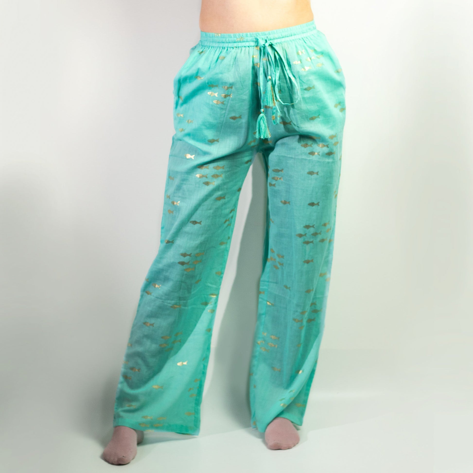 Nomad Sari Hand Painted Eco-Friendly 100% Cotton Lounge Pants - Medium - Large / Golden Fish / Turquoise product packaging on clean background from Quintessential Holistic Health Ltd