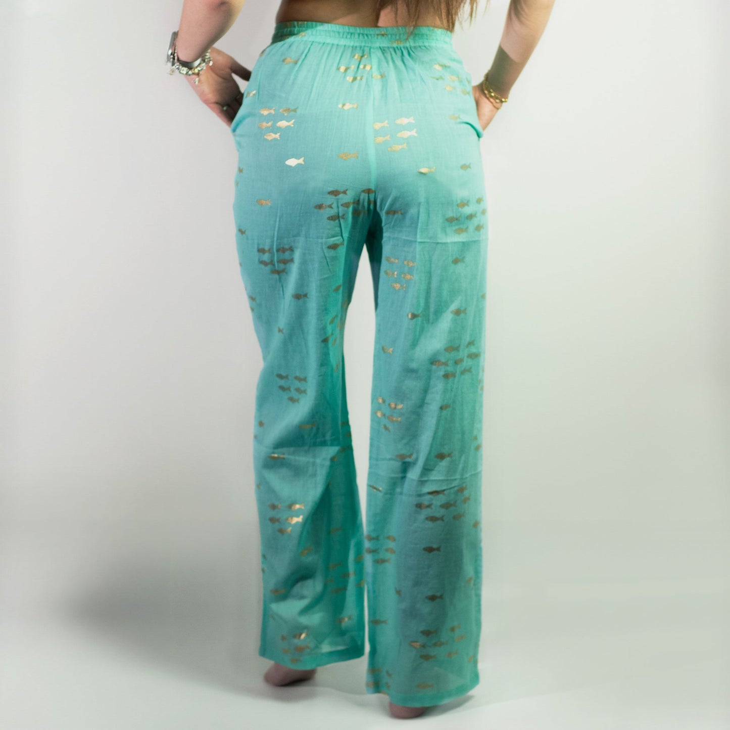 Nomad Sari Hand Painted Eco-Friendly 100% Cotton Lounge Pants - Medium - Large / Golden Fish / Turquoise product packaging on clean background from Quintessential Holistic Health Ltd