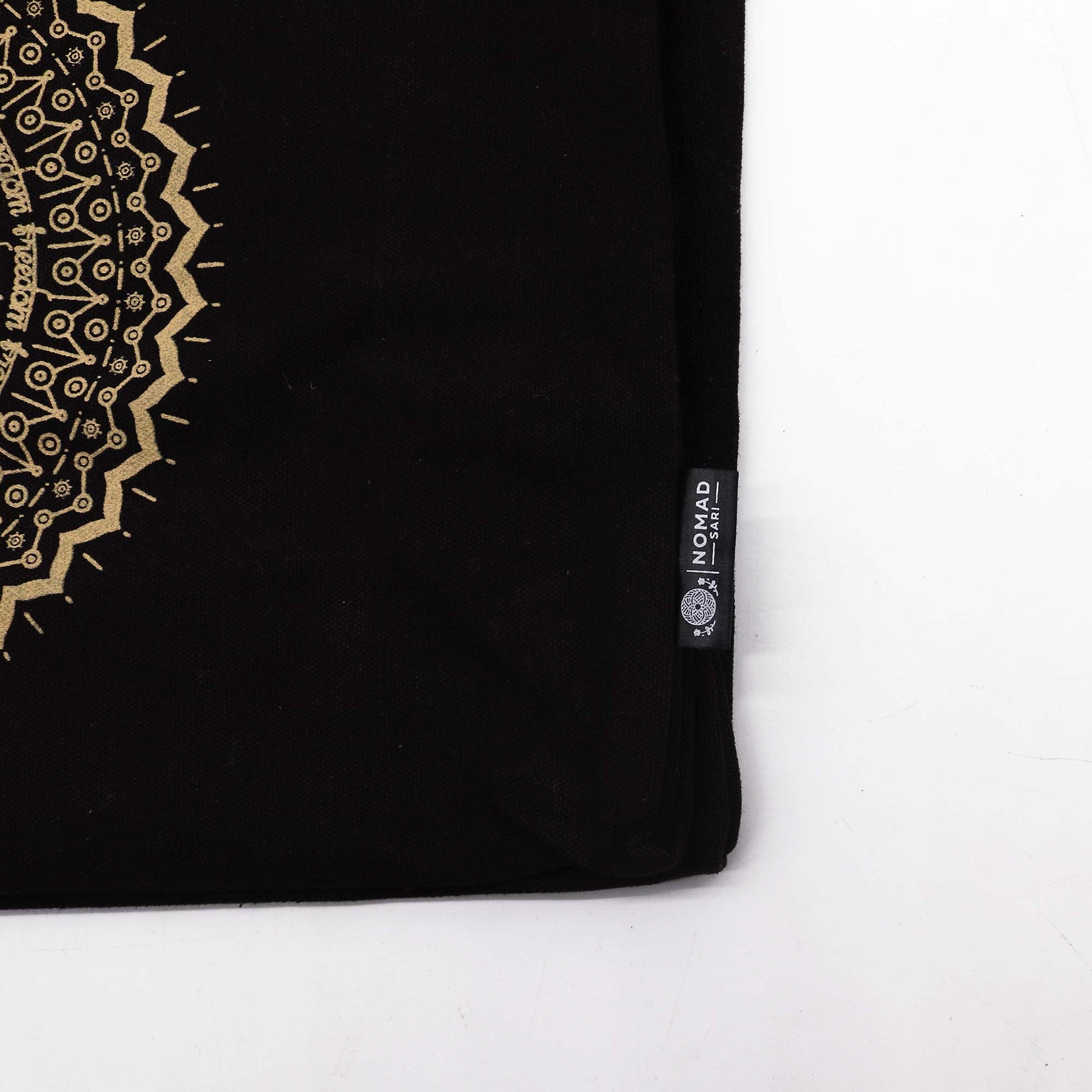 XL Stonewashed Chocolate/Gold Cotton Tote Bag - Freedom Mandala showing black fabric, cream trim, a partial gold motif and side label by Quintessential Holistic Health Ltd