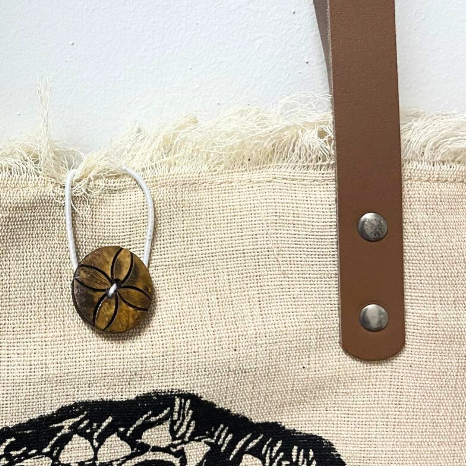 Natural Cotton Tote Bag with Leather Handles - Flower of Life showing a round flower charm, brown strap and metal rivets by Quintessential Holistic Health Ltd