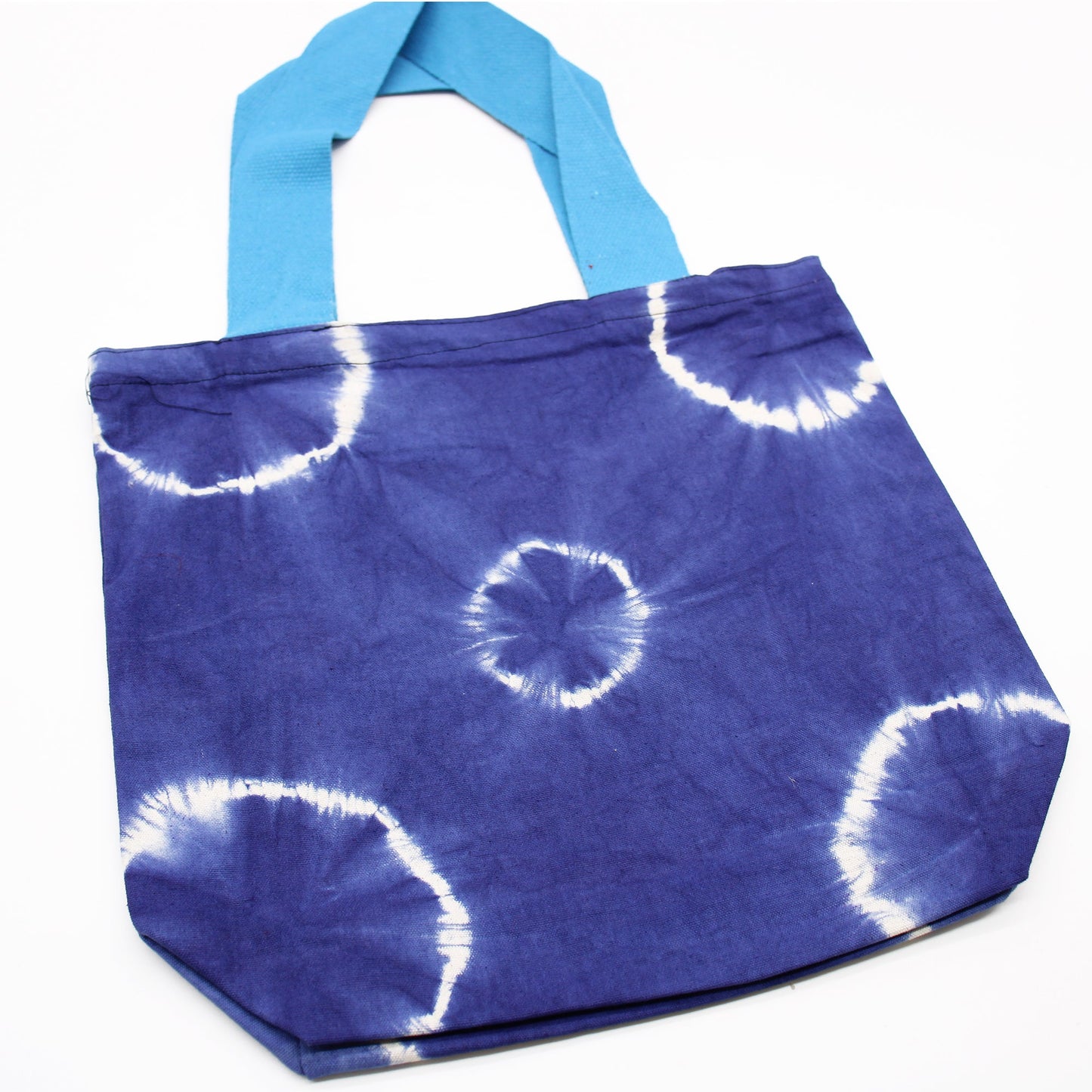 Handmade Eco-Friendly 100% Natural Cotton Tie-Dyed Bag - Blue Rings with a Blue Handle product packaging on clean background from Quintessential Holistic Health Ltd