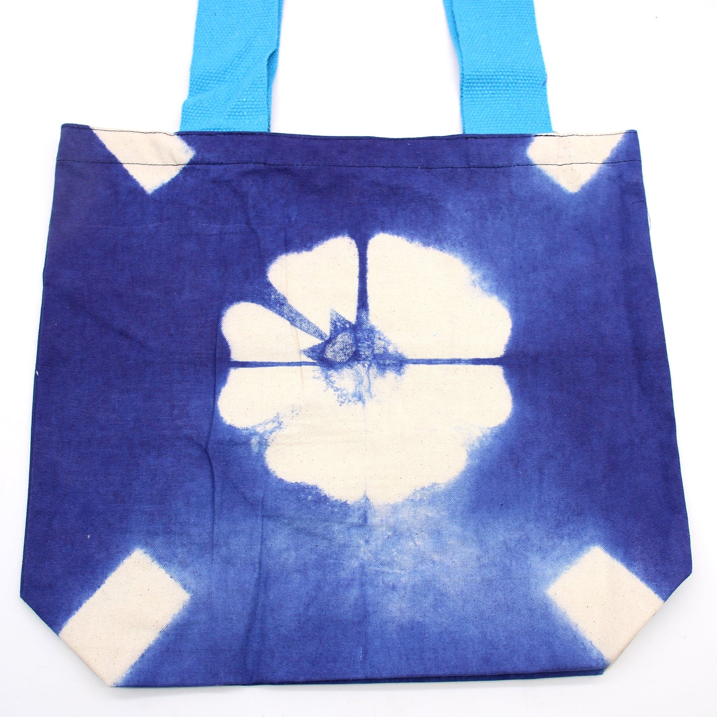 Handmade Eco-Friendly 100% Natural Cotton Tie-Dyed Bag - Blue Flower with a Blue Handle product packaging on clean background from Quintessential Holistic Health Ltd