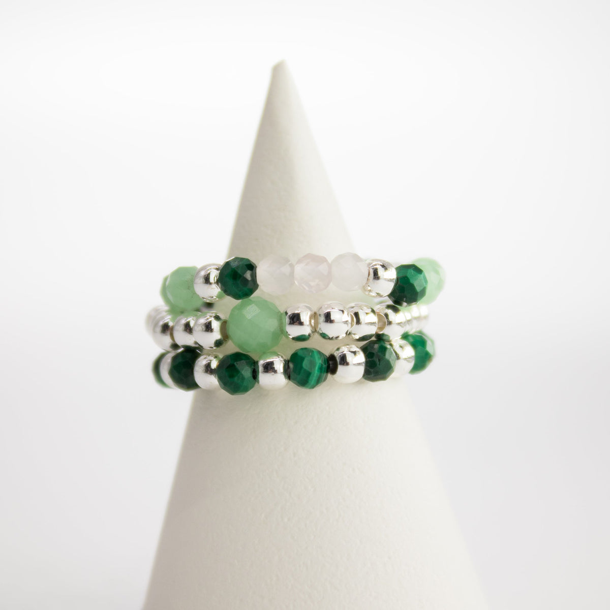 Mystical Nymph Spirit Gemstone 3-Ring Set – Forest Spirit, green, translucent and silver-toned beaded rings stacked on a white cone, by Quintessential Holistic Health Ltd