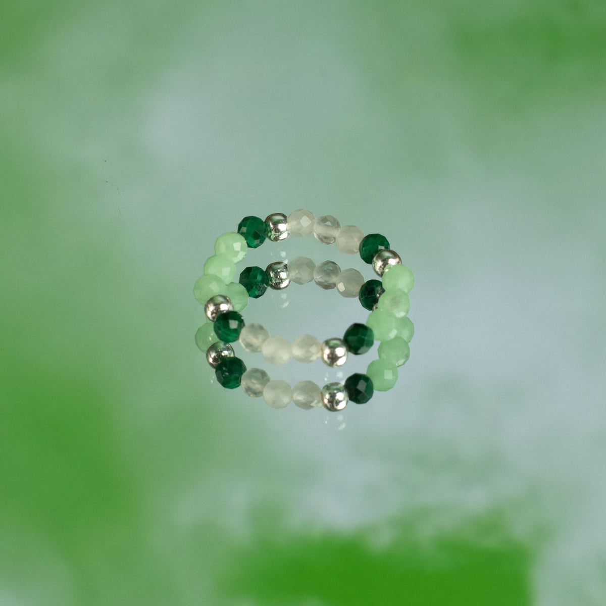 Mystical Nymph Spirit Gemstone 3-Ring Set – Forest Spirit, pale and green beaded rings stacked together on soft green by Quintessential Holistic Health Ltd