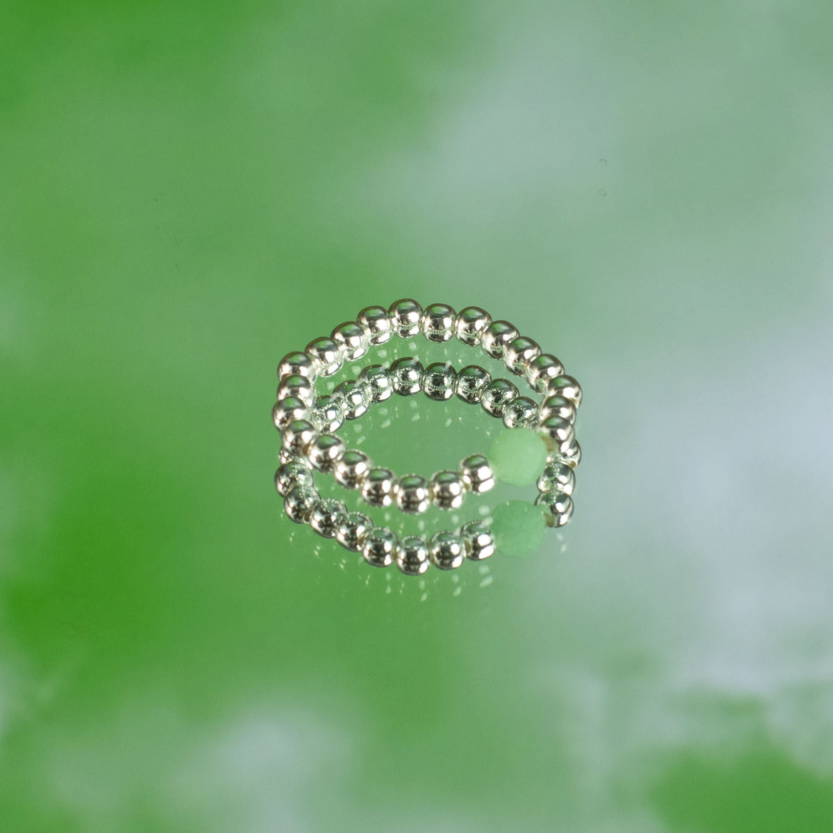 Mystical Nymph Spirit Gemstone 3-Ring Set – Forest Spirit, three silver-toned beaded rings stacked on a green surface by Quintessential Holistic Health Ltd