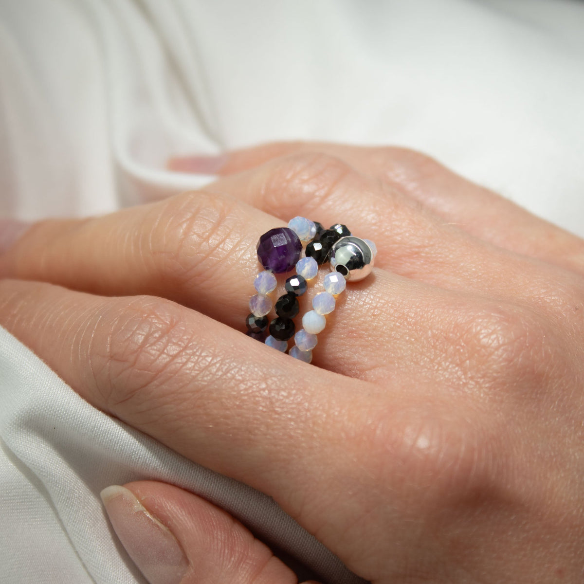 Mystical Nymph Spirit Gemstone 3-Ring Set – Full Moon, purple, pale blue and silver-toned beaded rings worn stacked on a hand, by Quintessential Holistic Health Ltd